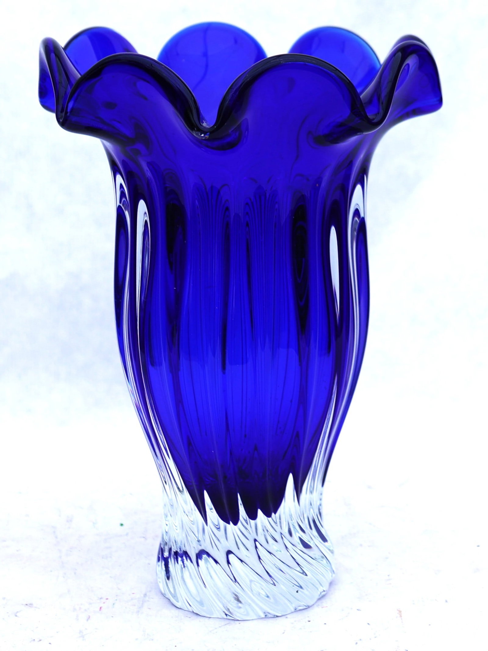 Shannon Crystal "Designs of Ireland" cobalt blue ruffled vase.The vase features a distinctive cobalt: Size: 11 1/2 in height, 7 1/2 in. wide ; Shannon Crystal "Designs of Ireland" cobalt blue ruffled vase.The vase features a distinctive cobalt blue top that transitions to a clear, ribbed base.
