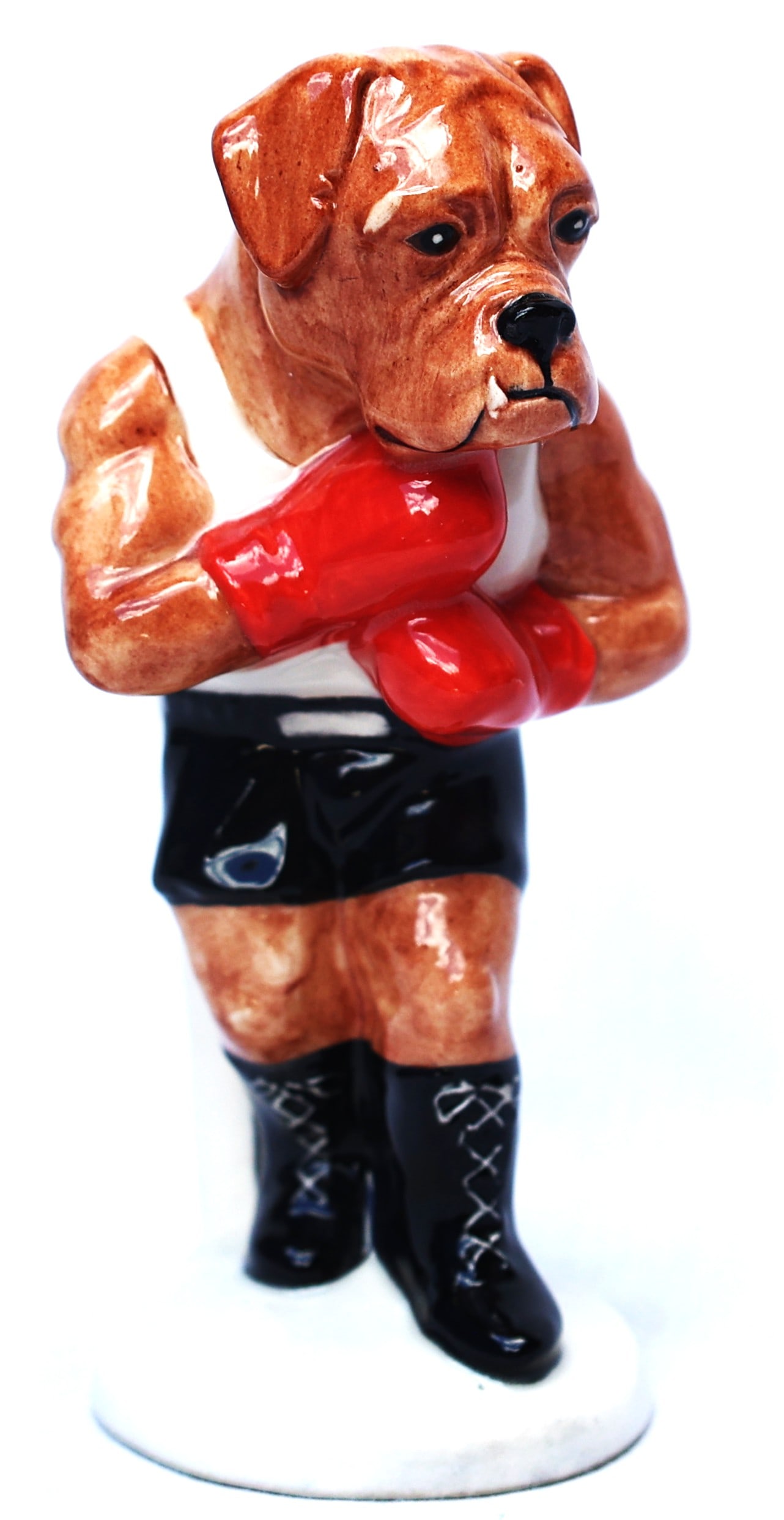 Beswick "It's A Knockout" boxer dog figurine featuring a tan-colored boxer head on a human body.: Size: 5 1/4 in. height, 2 3/8 in. base ; Beswick "It's A Knockout" boxer dog figurine featuring a tan-colored boxer head on a human body.