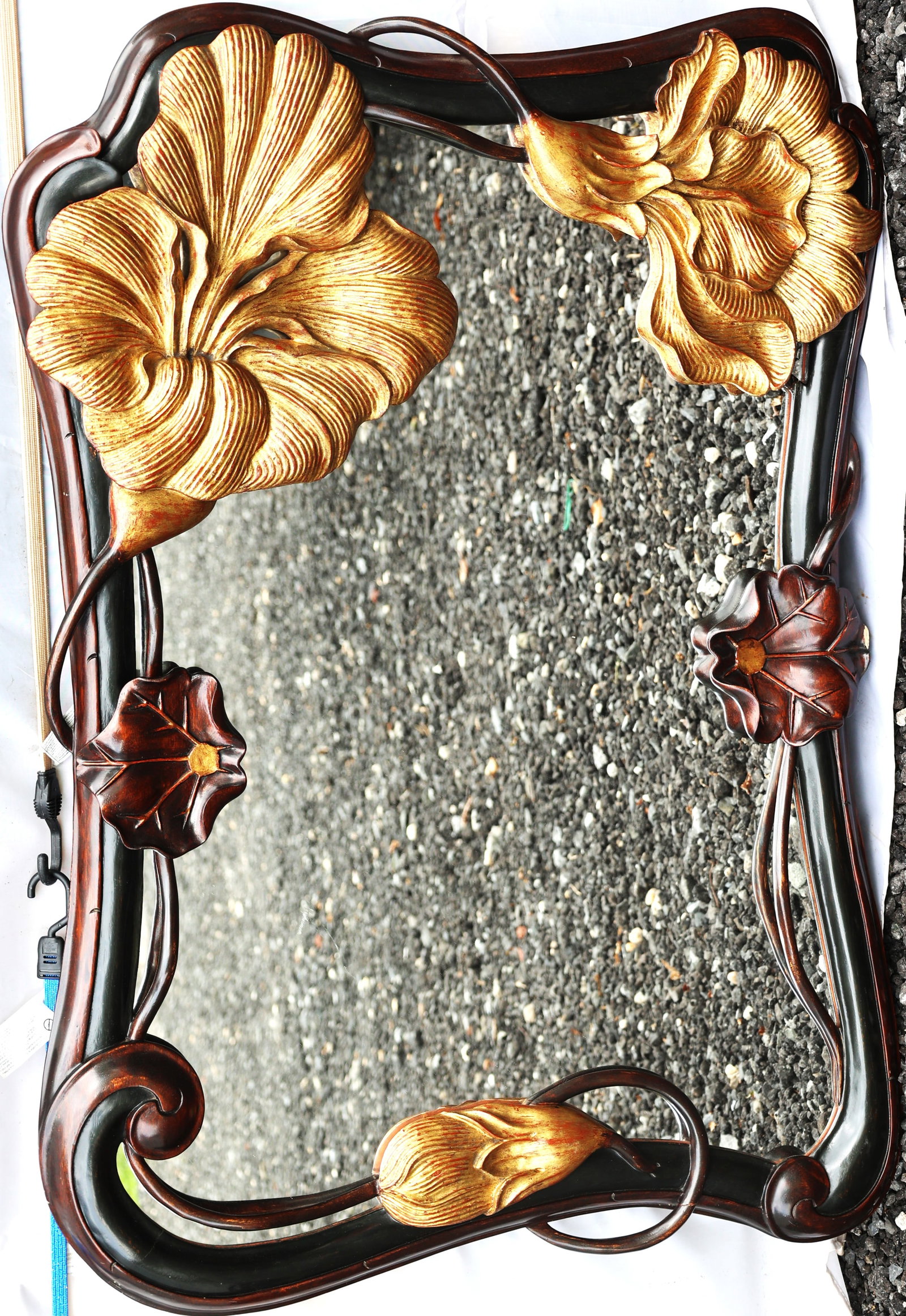 Art Nouveau style mirror features a dark carved mahogany frame decorated with gilt-accented floral m: Size: outer 46 inches x 31 inches ; Art Nouveau style mirror features a dark carved mahogany frame decorated with gilt-accented floral motifs.