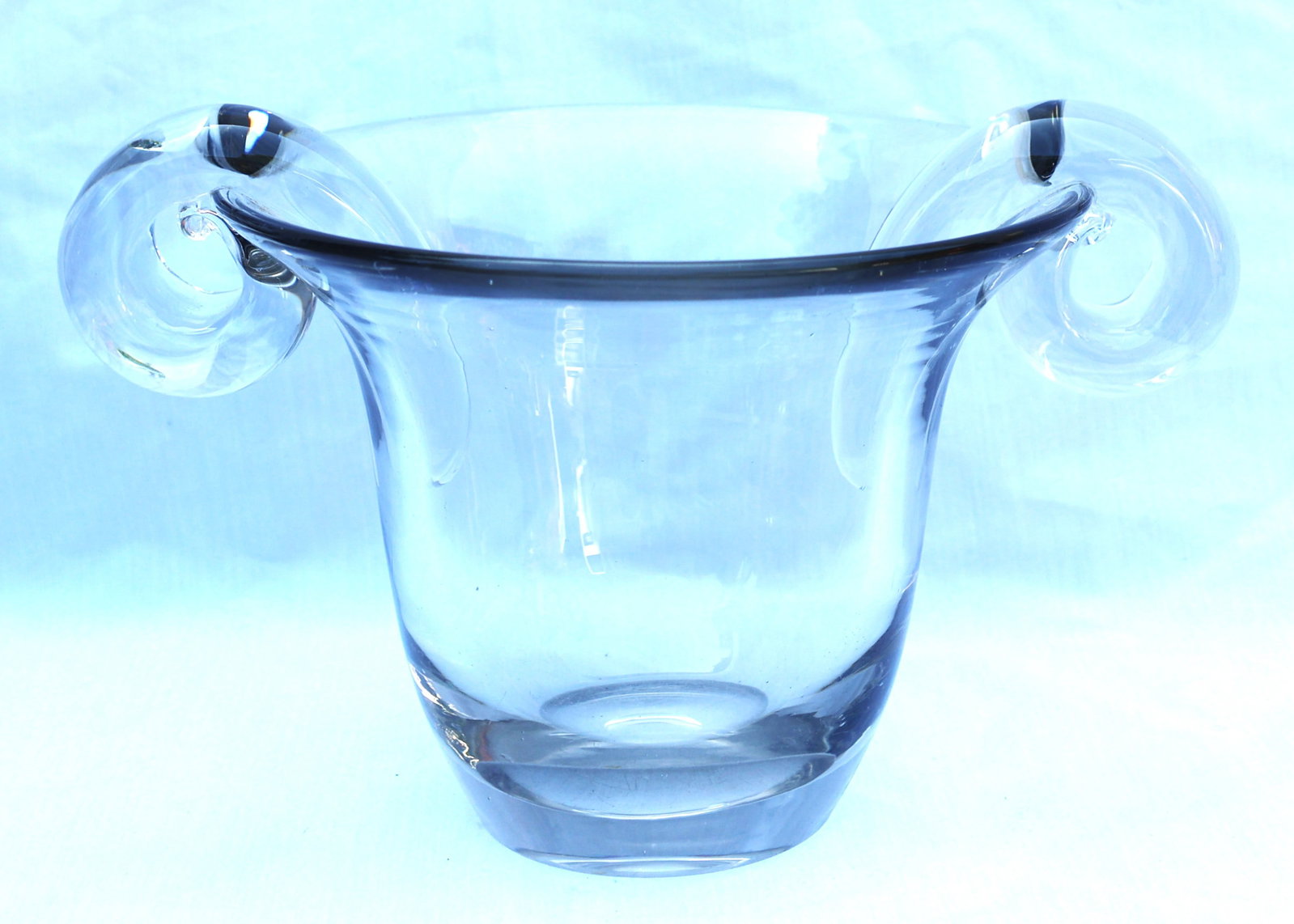 clear glass vase is a 1920s Art Deco piece featuring distinct applied loop handles and a polished po: Size: 7 in. height, 12 in. length handle to handle, 9 in. diameter, 3 3/4 in. base / clear glass vase is a 1920s Art Deco piece featuring distinct applied loop handles and a polished pontil