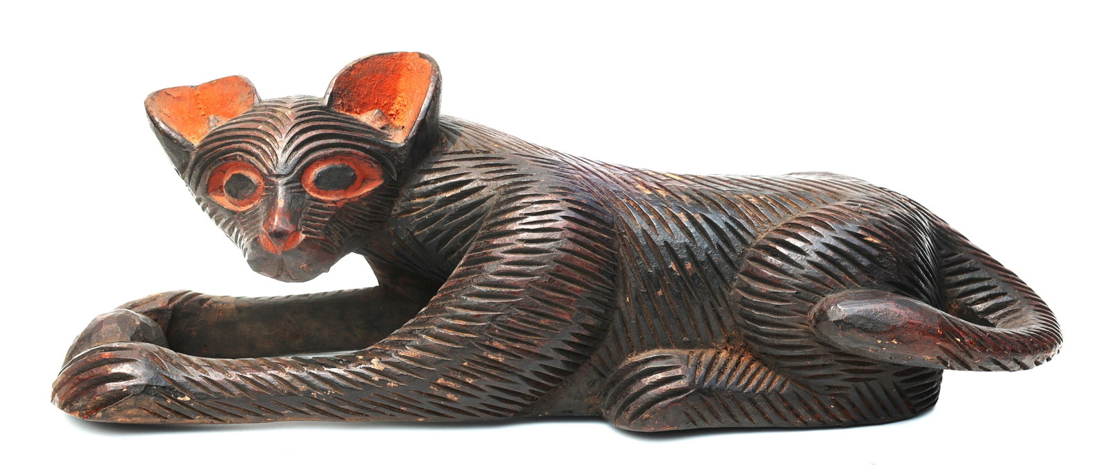 carved wooden cat sculpture, often identified as Indonesian or Thai folk art.It typically features a: Size: 21.5 in. length, 6.5 in. wide, 6.5 in. height ; carved wooden cat sculpture, often identified as Indonesian or Thai folk art.It typically features a dark stain with contrasting orange or red pai