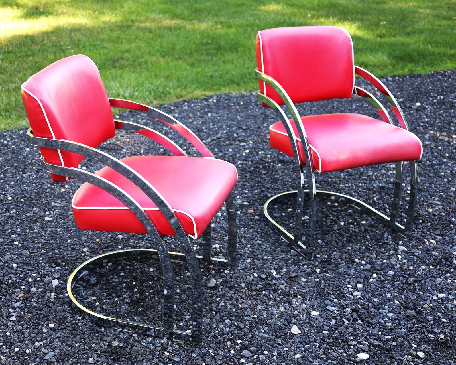 Streamline Art Deco cantilever armchairs featuring chrome frames and red vinyl upholstery, often att: Size: 32 in. height, 19 1/2 in. wide, 24 in. depth ; Streamline Art Deco cantilever armchairs featuring chrome frames and red vinyl upholstery, often attributed to designer KEM Weber for Lloyd Manufac