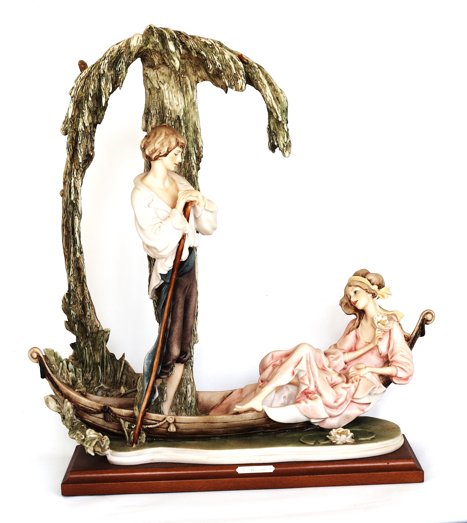 "Gita In Barca" (Boat Trip) figurine by artist Giuseppe Armani for Florence Capodimonte, featuring: Size: 16 1/2 in. height x 15 in. wide ; "Gita In Barca" (Boat Trip) figurine by artist Giuseppe Armani for Florence Capodimonte, featuring a couple in a boat beneath a weeping willow tree