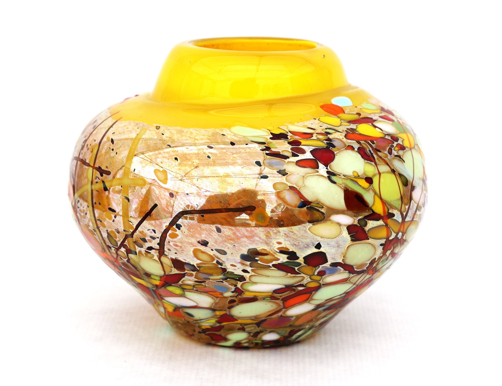 Signed Murano-style art glass piece featuring a vibrant millefiori pattern and a distinct yello: Size: 5 in. height; 6 in. wide; 2 1/8 in. top opening ; Signed handcrafted Murano-style art glass piece featuring a vibrant millefiori pattern and a distinct yellow neck