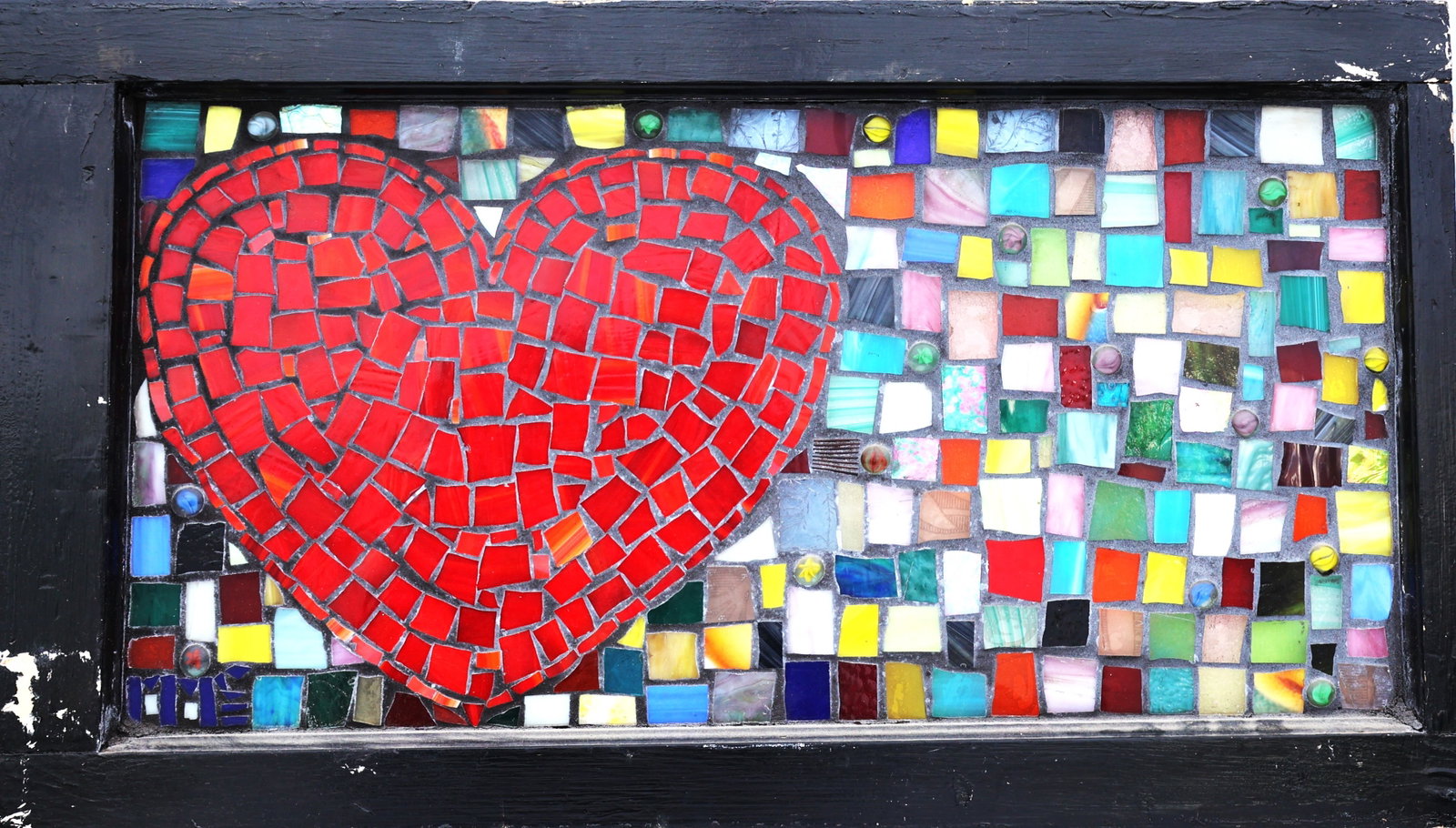 1950's mosaic artwork window features a prominent red heart composed of small glass fragments (1 of 5)