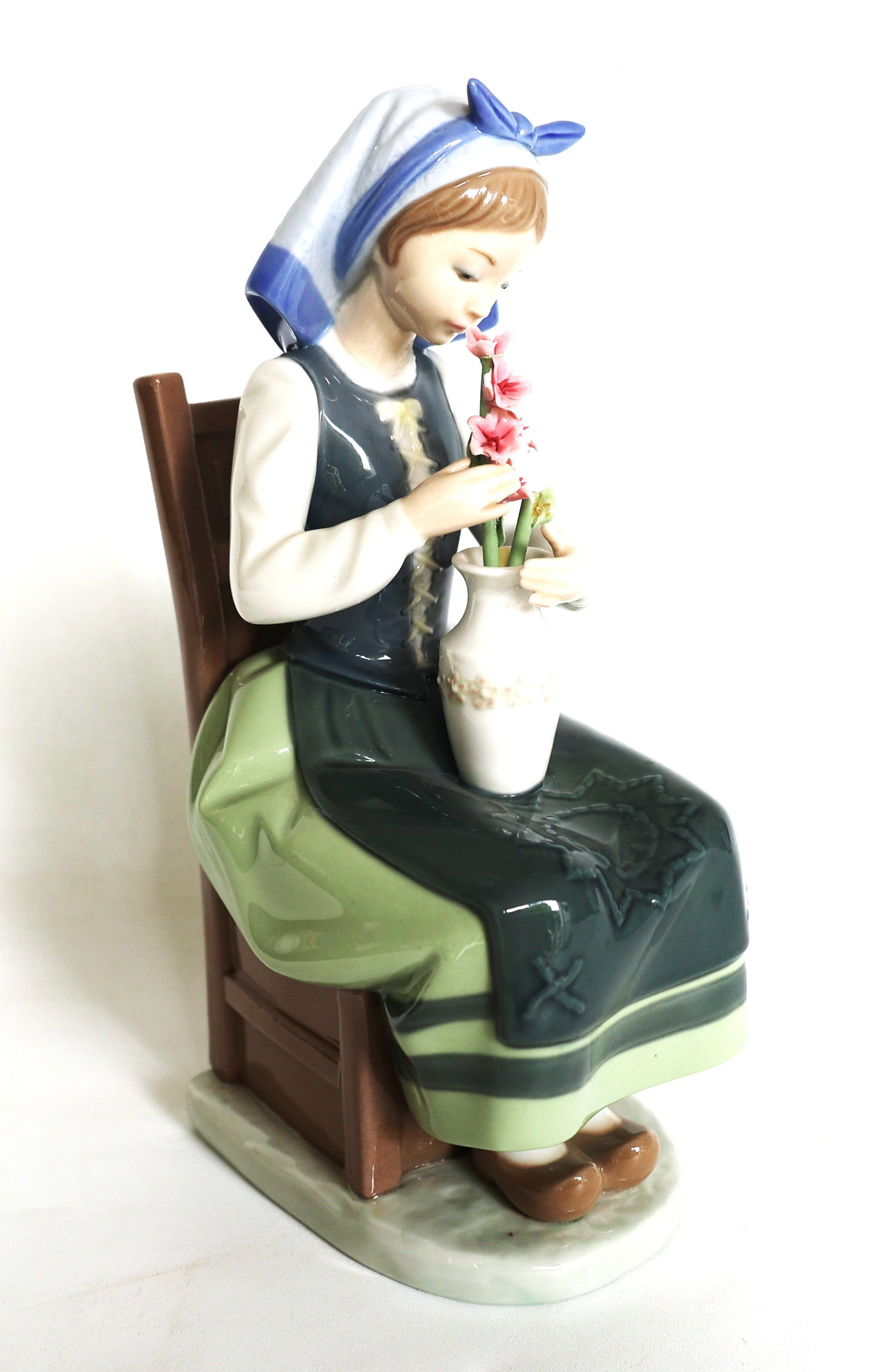 Lladró "Flower Harmony" porcelain figurine features a young girl in traditional attire seated on a (1 of 6)