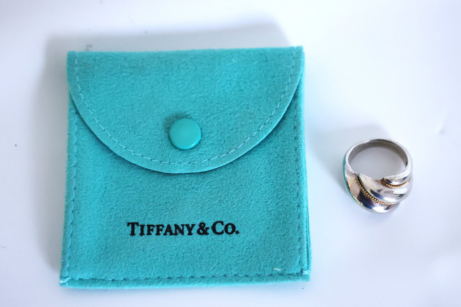 Tiffany & Co .925 Sterling Silver and 750 [18K Gold] 5.16 Grams Rope Twist Ring Size 5: Tiffany & Co .925 Sterling Silver and 750 [18K Gold] 5.16 Grams Rope Twist Ring Size 5, with Fabric Pouch. ring 3/4 in. x 5/8 in.