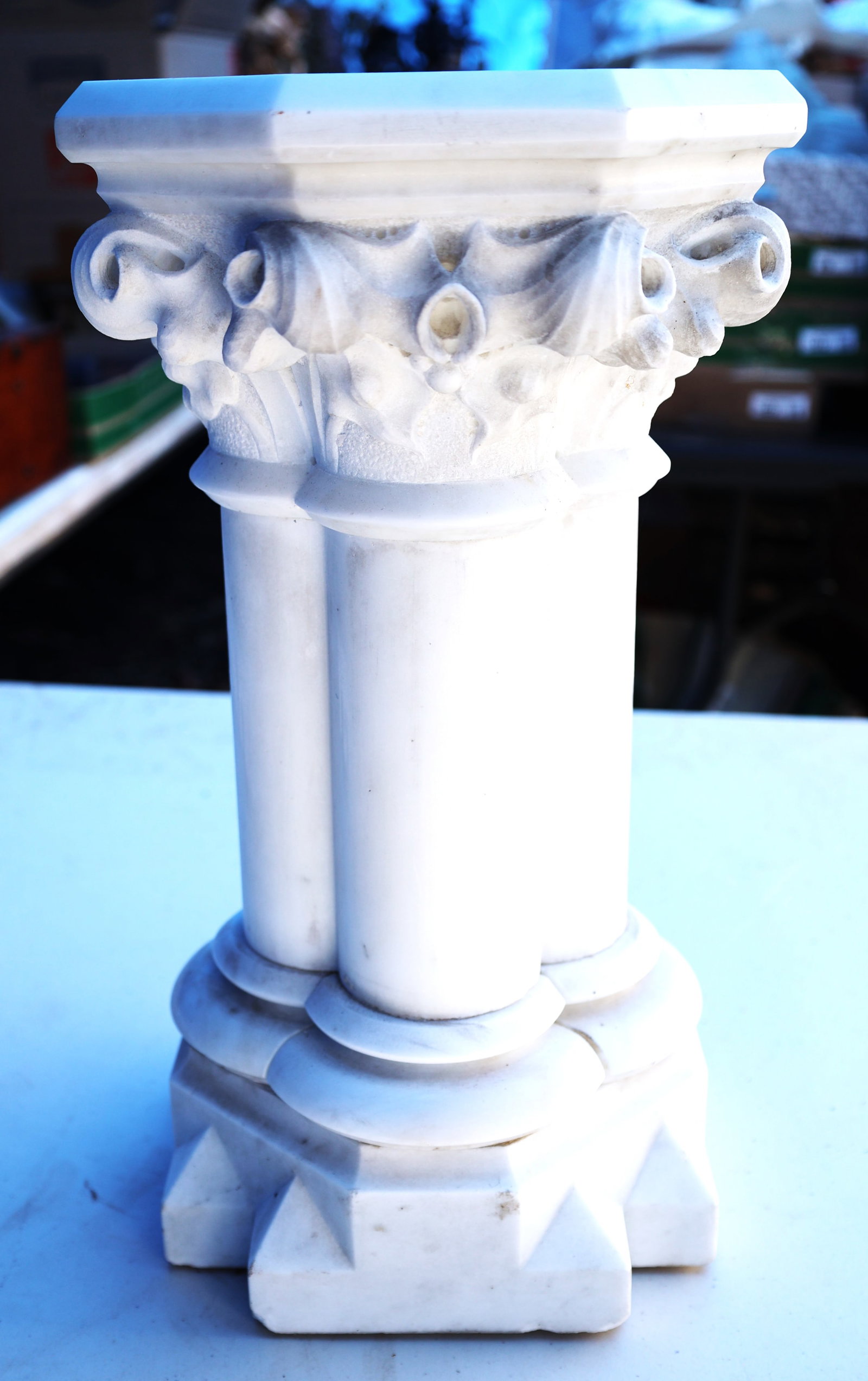 Marblebee white stone column pedestal, featuring intricate hand-carved floral detailing on its capit (1 of 5)