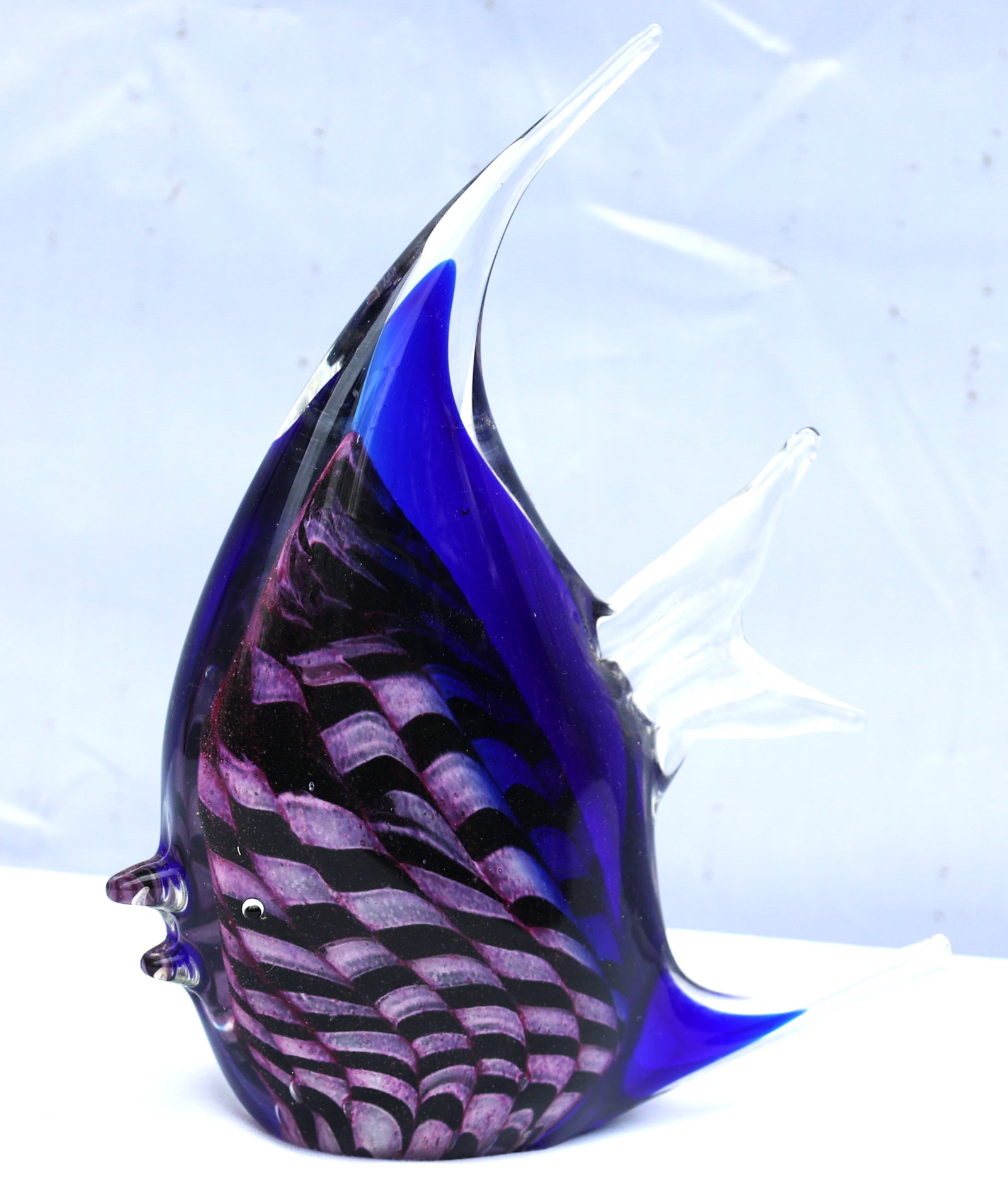 Pasabahce Cesm-i Bulbul fish glass object featuring a blue body with a spiraling black and white "ni: Size: 9 in. height x 7 in. wide; Pasabahce Cesm-i Bulbul fish glass object featuring a blue body with a spiraling black and white "nightingale's eye" design