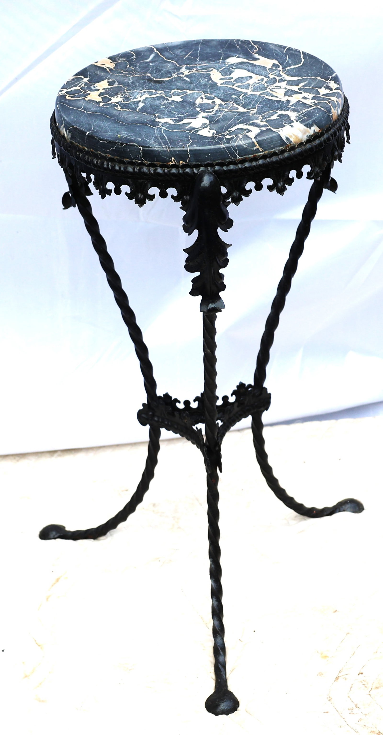 This is a vintage wrought iron pedestal stand table, often featuring a black and white veined marble (1 of 5)