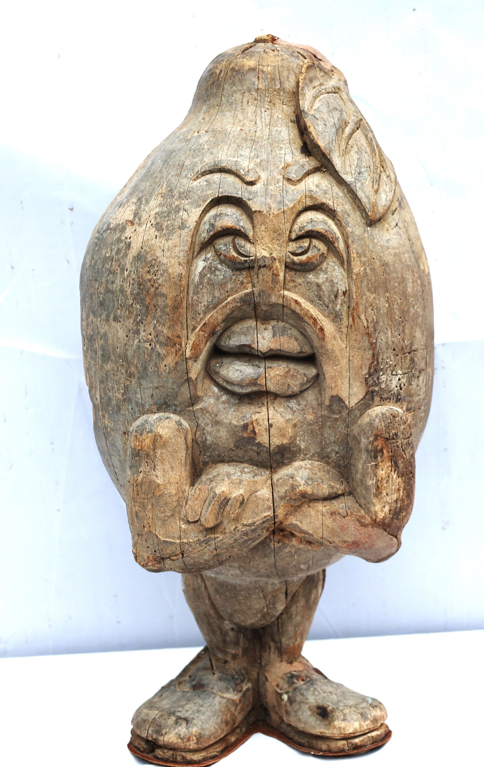 wooden sculpture appears to be a form of folk art or a primitive carving.The figure resembles a "Hum (1 of 6)