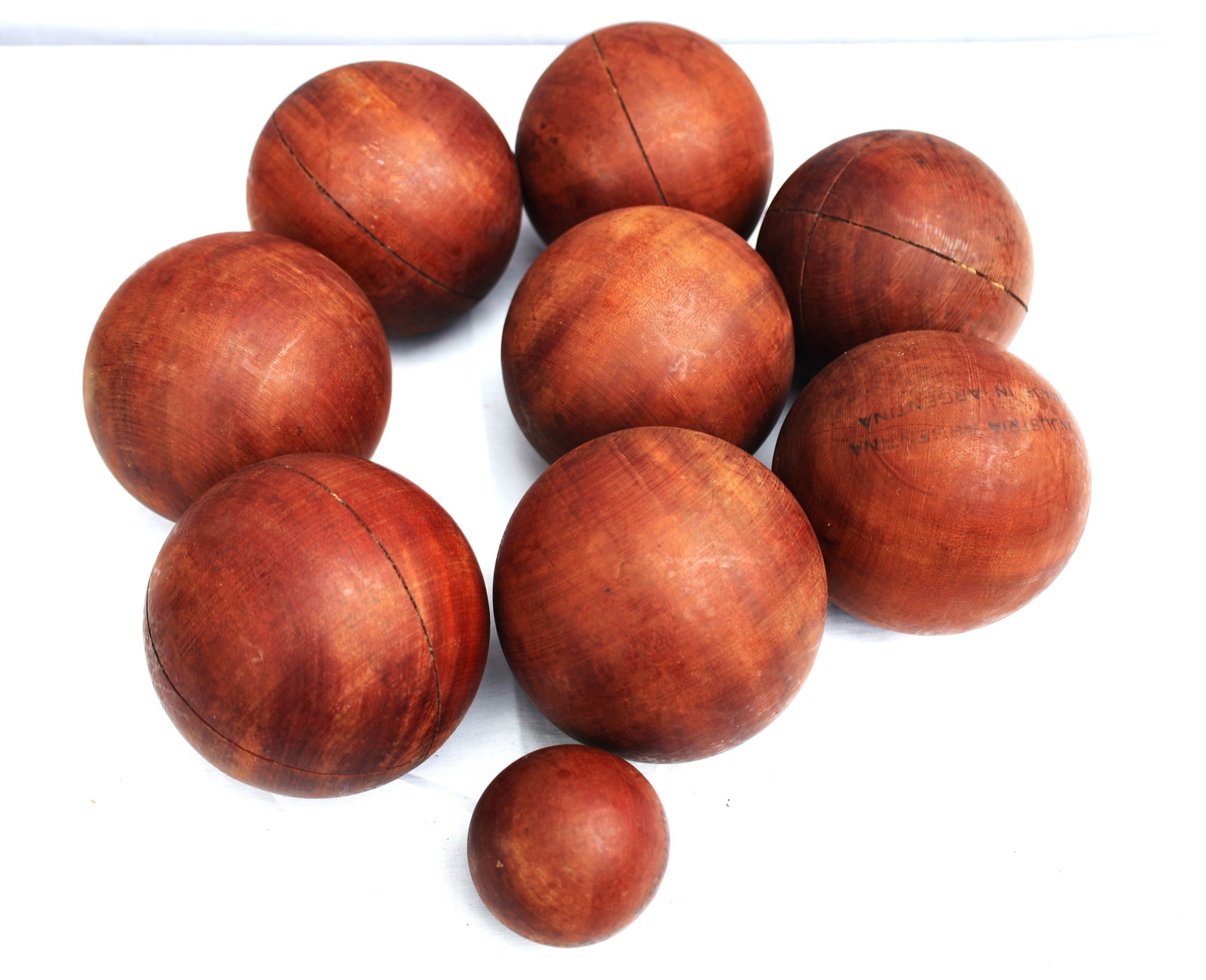 9 Bocce Balls, Antique, Industria Argentina: Size: 8 are 4 inches diameter; 1 is 2 1/2 in. diameter; 9 Bocce Balls, Antique, Industria Argentina