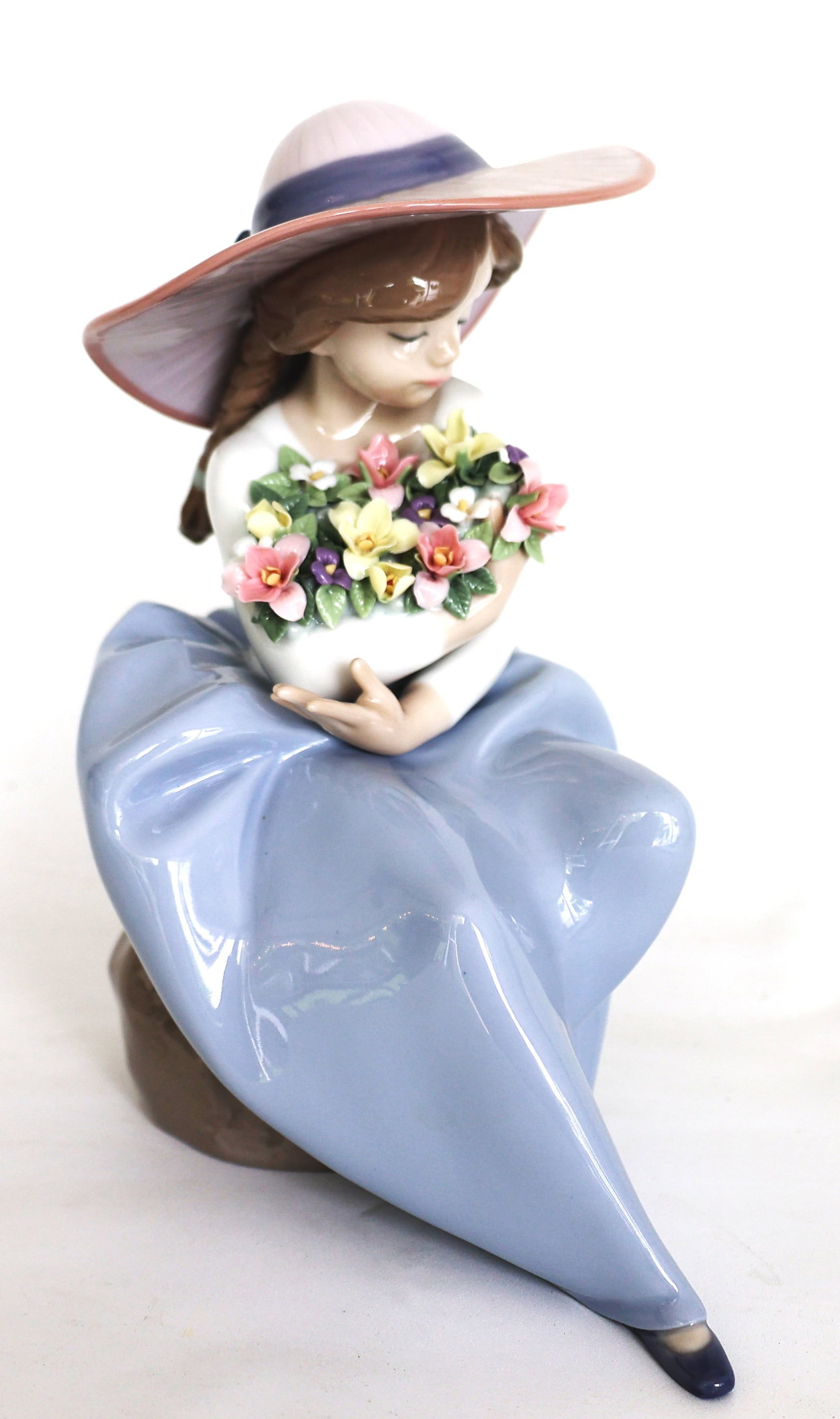 Lladro "Fragrant Bouquet" Porcelain Figurine, a glazed Spanish sculpture featuring a young girl wear: Size: 8 in. x 6 1/2 in. x 4 in.; Lladro "Fragrant Bouquet" Porcelain Figurine, a glazed Spanish sculpture featuring a young girl wearing a hat and holding a bouquet of flowers