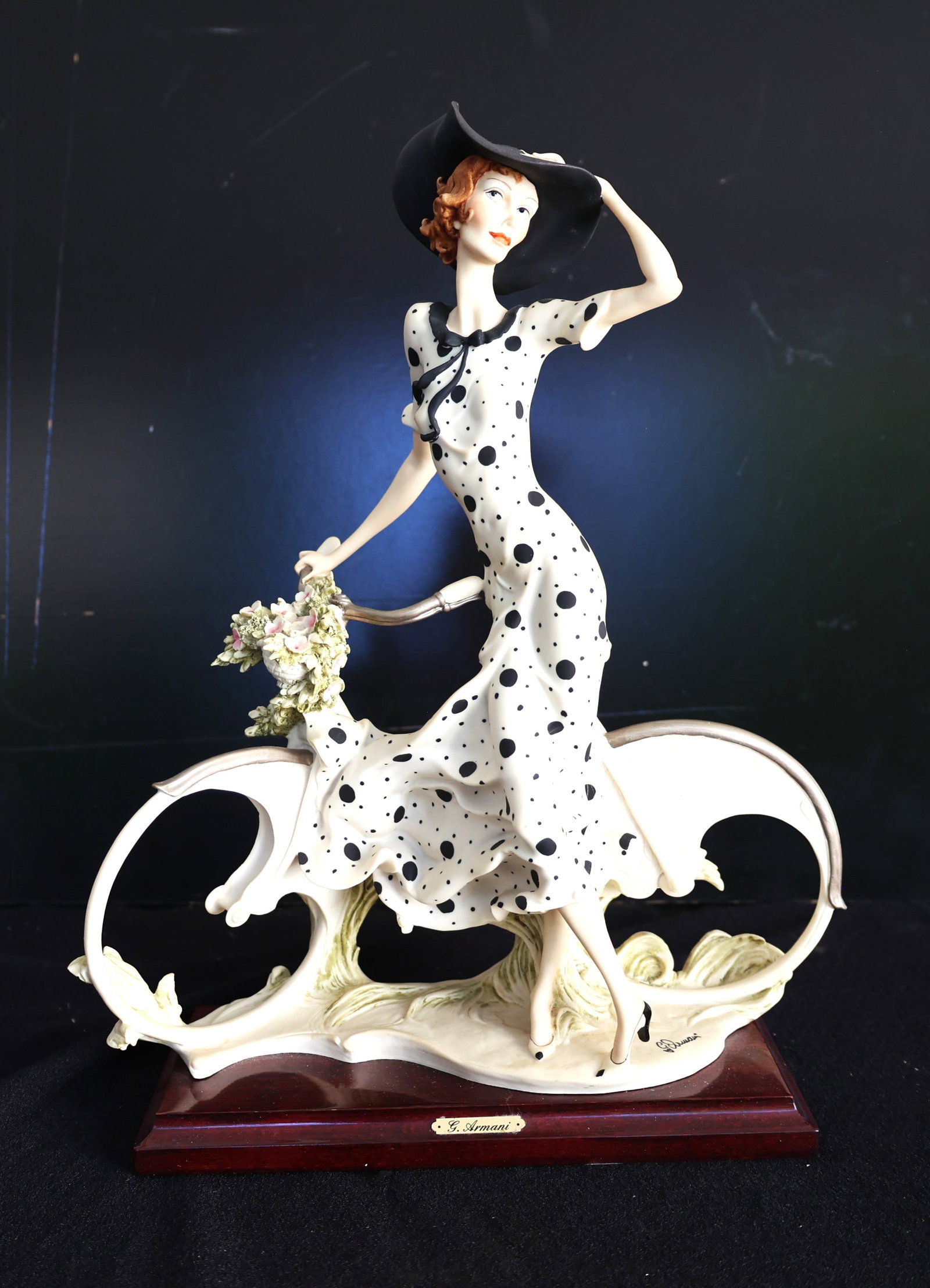 Giuseppe Armani "Girl With Bicycle - Spring" figurine, a cold-cast porcelain piece featuring a woman: Size: 15 in. height, 11 in. wide, 4 1/2 in. x 9 1/2 in. base ; Giuseppe Armani "Girl With Bicycle - Spring" figurine, a cold-cast porcelain piece featuring a woman in a black and white polka dot dress