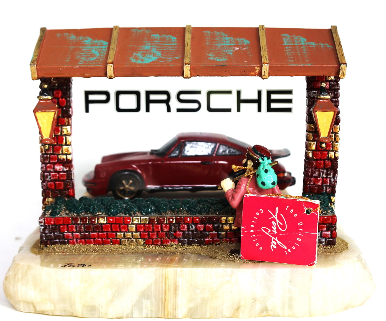 Ron Lee "Wishful Thinking" sculpture featuring a red Porsche 911 in a showroom.: Size: 8 in. height, 9 1/2 in. wide x 8 in. depth ; Ron Lee "Wishful Thinking" sculpture featuring a red Porsche 911 in a showroom.The sculpture depicts a hobo clown looking through the window at the