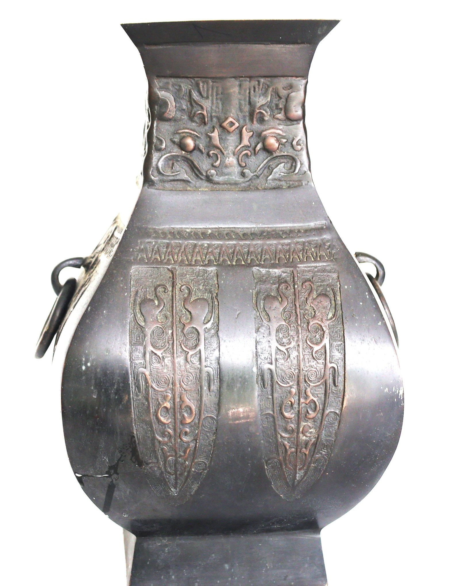 Chinese archaistic bronze vase (specifically a hu form) decorated with taotie mask designs.: Size: 13 1/2 in. height, 8 in, x 8 in. ; Chinese archaistic bronze vase (specifically a hu form) decorated with taotie mask designs.While styled after ancient bronze vessels, pieces like this were