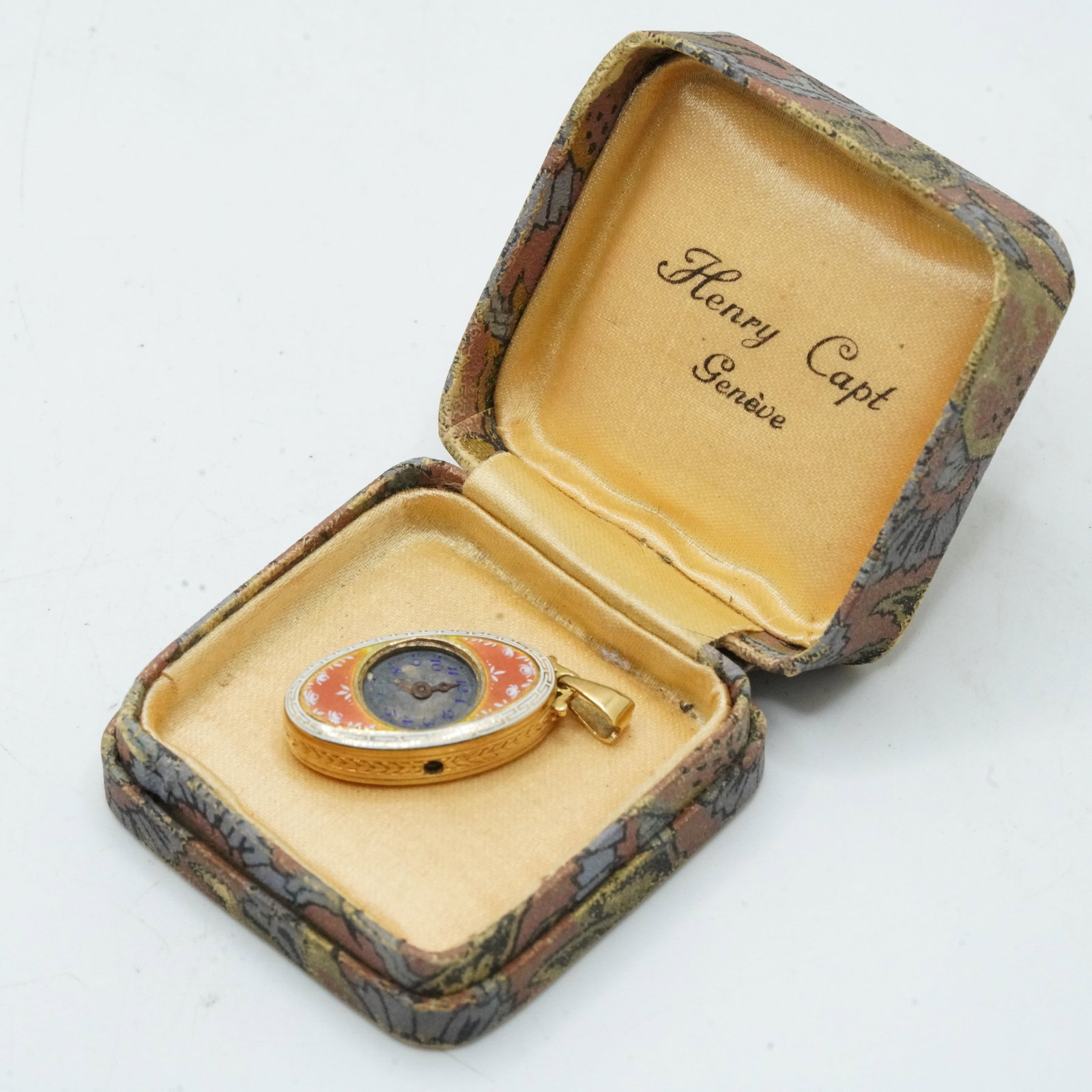marked 750 [18K] Yellow Gold 3.34 DWT Not Including Mechanisn Guilloche Pendant Watch: marked 750 [18K] Yellow Gold 3.34 DWT Not Including Mechanisn Guilloche Pendant Watch, Case is Yellow Gold with Pink and White Enameling, full weight including mechanism 6.22 DWT. Size: 1 1/4 in. x 1/