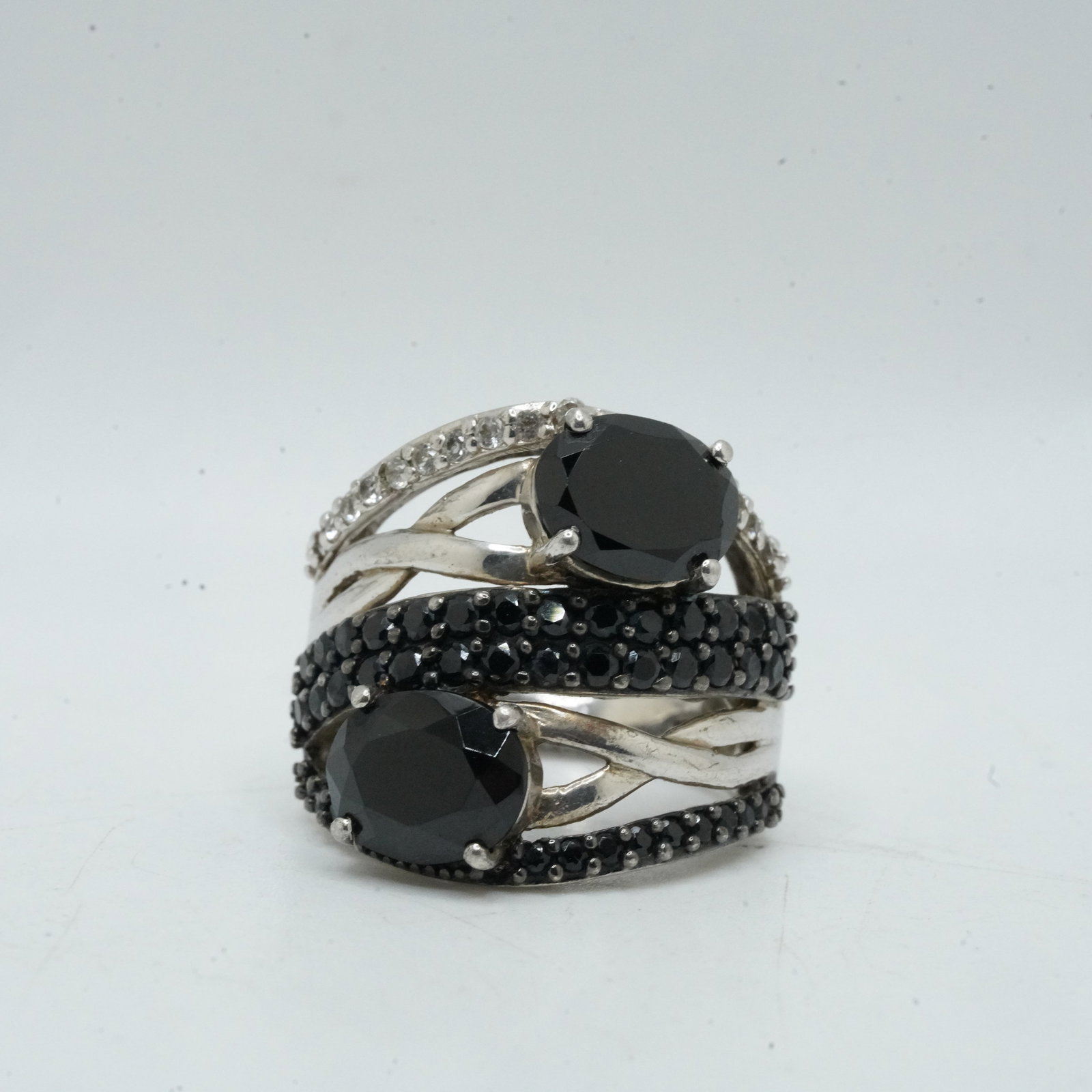 .925 Sterling Silver 9.85 Grams, 2 Large Black Onyx Stones Separated 3 Rows Black Onyx Lines Ring: .925 Sterling Silver 9.85 Grams, 2 Large Black Onyx Stones Separated by 3 Rows Black Onyx Lines and one row of white topaz Ring Size 8.25 , 1 in. x 1 in.