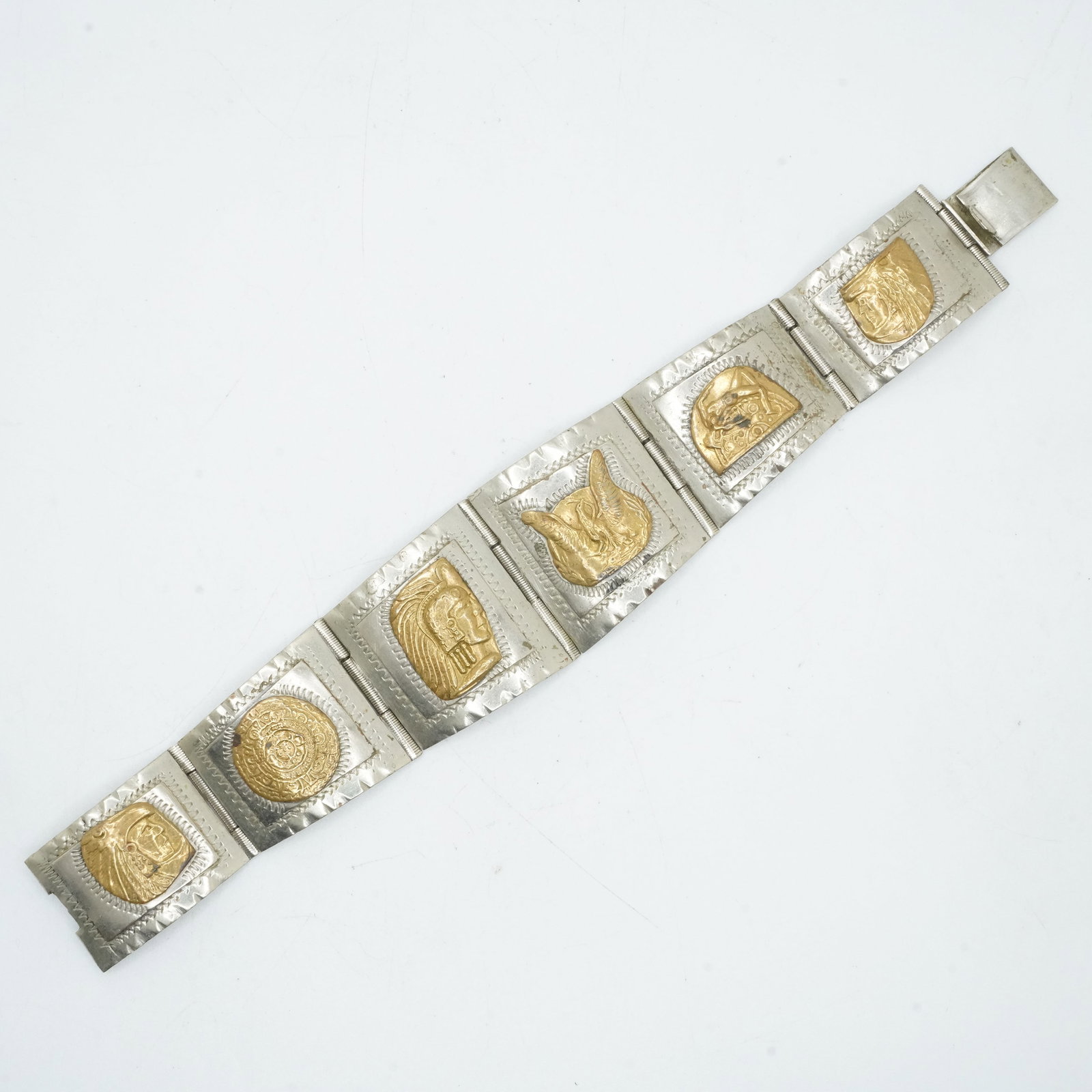 40.34 Grams .925 Sterling Silver 6-Graduating Panels with Brass Symbols Bracelet, Mexico 925: 40.34 Grams .925 Sterling Silver 6-Graduating Panels with Brass Symbols Bracelet, Mexico 925 ; 6 3/4 in. x 1 1/4 in. to 3/4 in.
