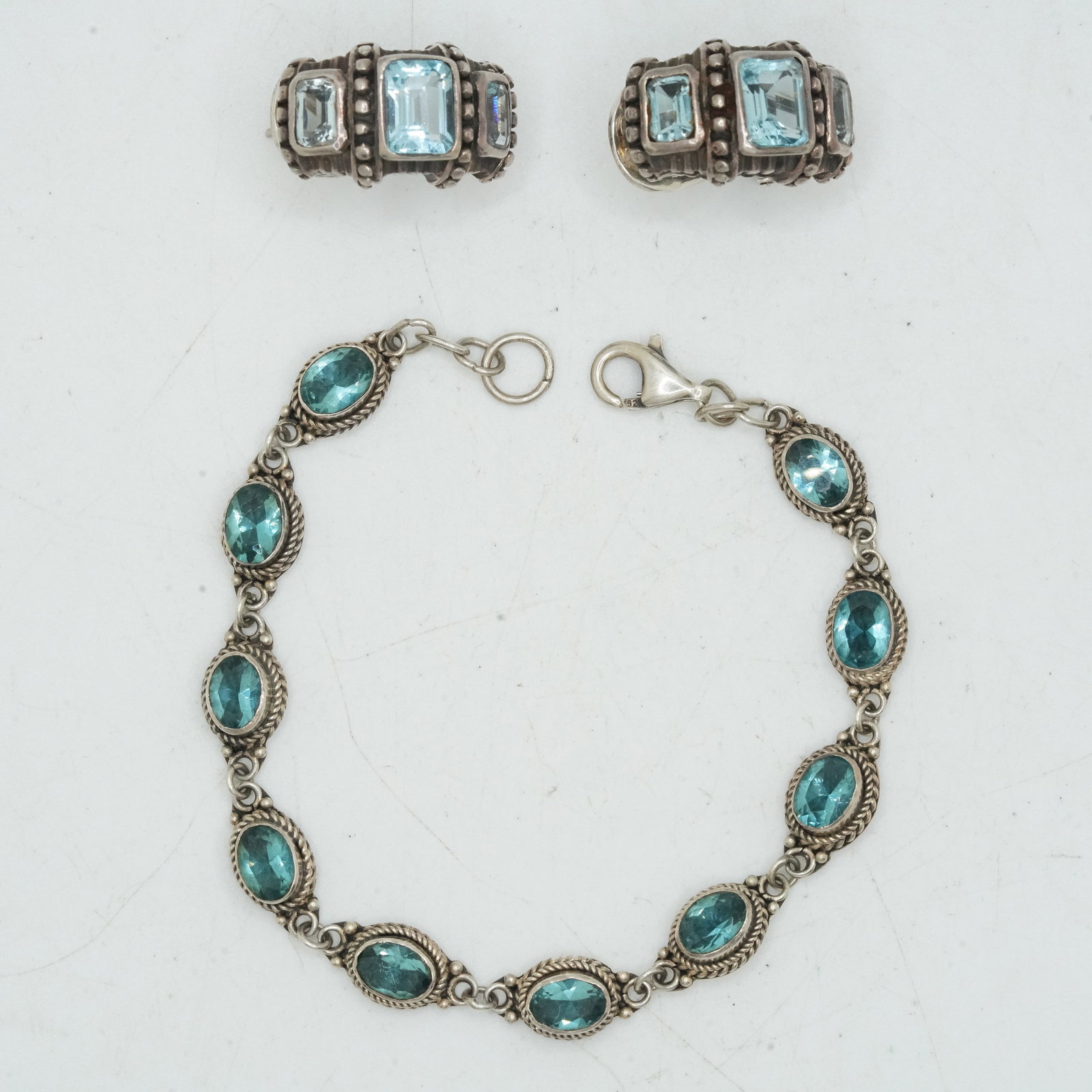 23.62 Grams .925 Sterling Silver Blue Topaz Pieced Earrings ; Novica .925 Blue Topaz Tennis Bracelet: 23.62 Grams .925 Sterling Silver Blue Topaz Pieced Earrings 7/8 in. x 1/2 in. ; Novica .925 Blue Topaz Tennis Bracelet 7 1/4 in. x 1/4 in.