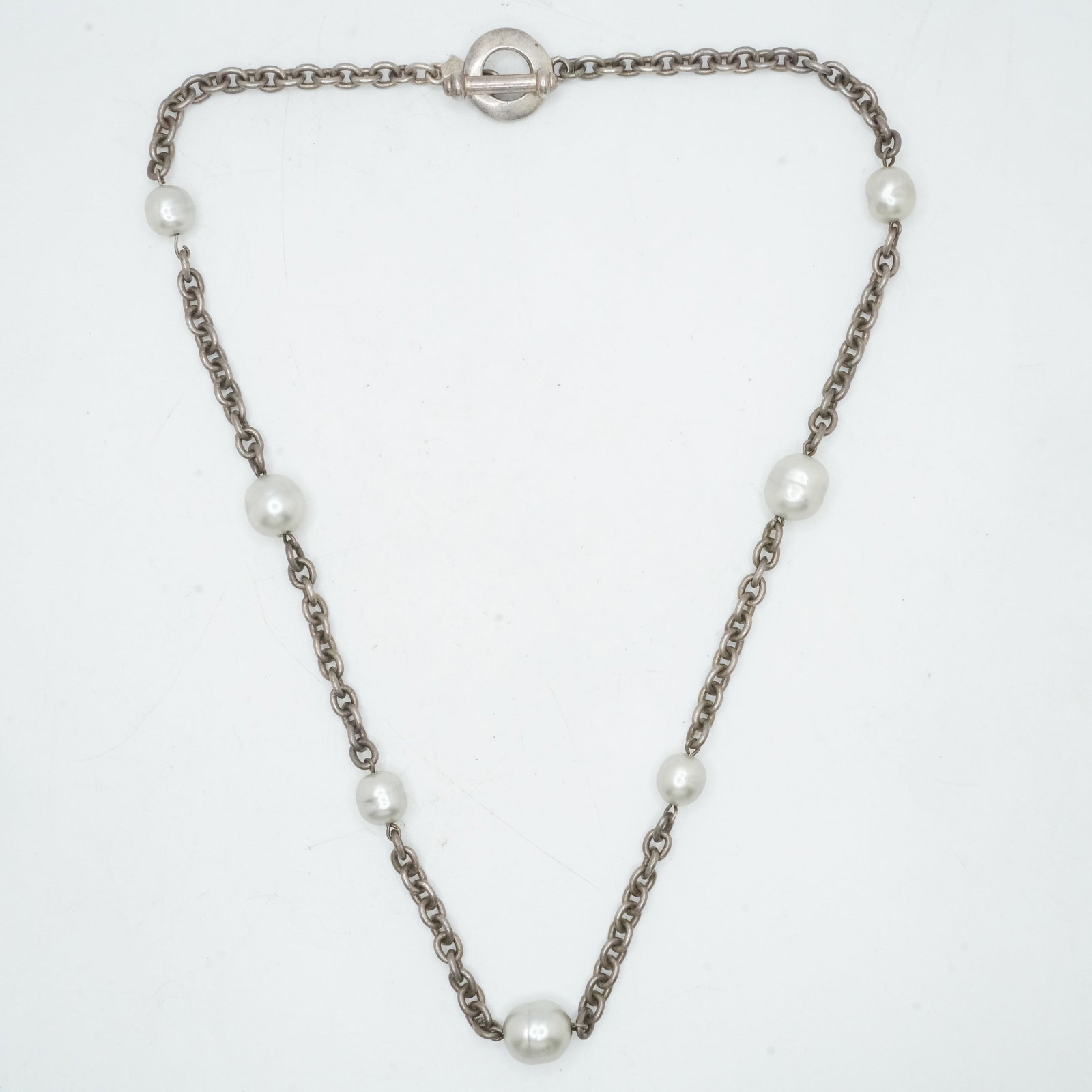 28.97 Grams 925 Sterling Silver Carolee Faux Pearls Necklace with Toggle Closure: 28.97 Grams 925 Sterling Silver Carolee Faux Pearls Necklace with Toggle Closure. 18 in. x 5/8 in. x 1/4 in.