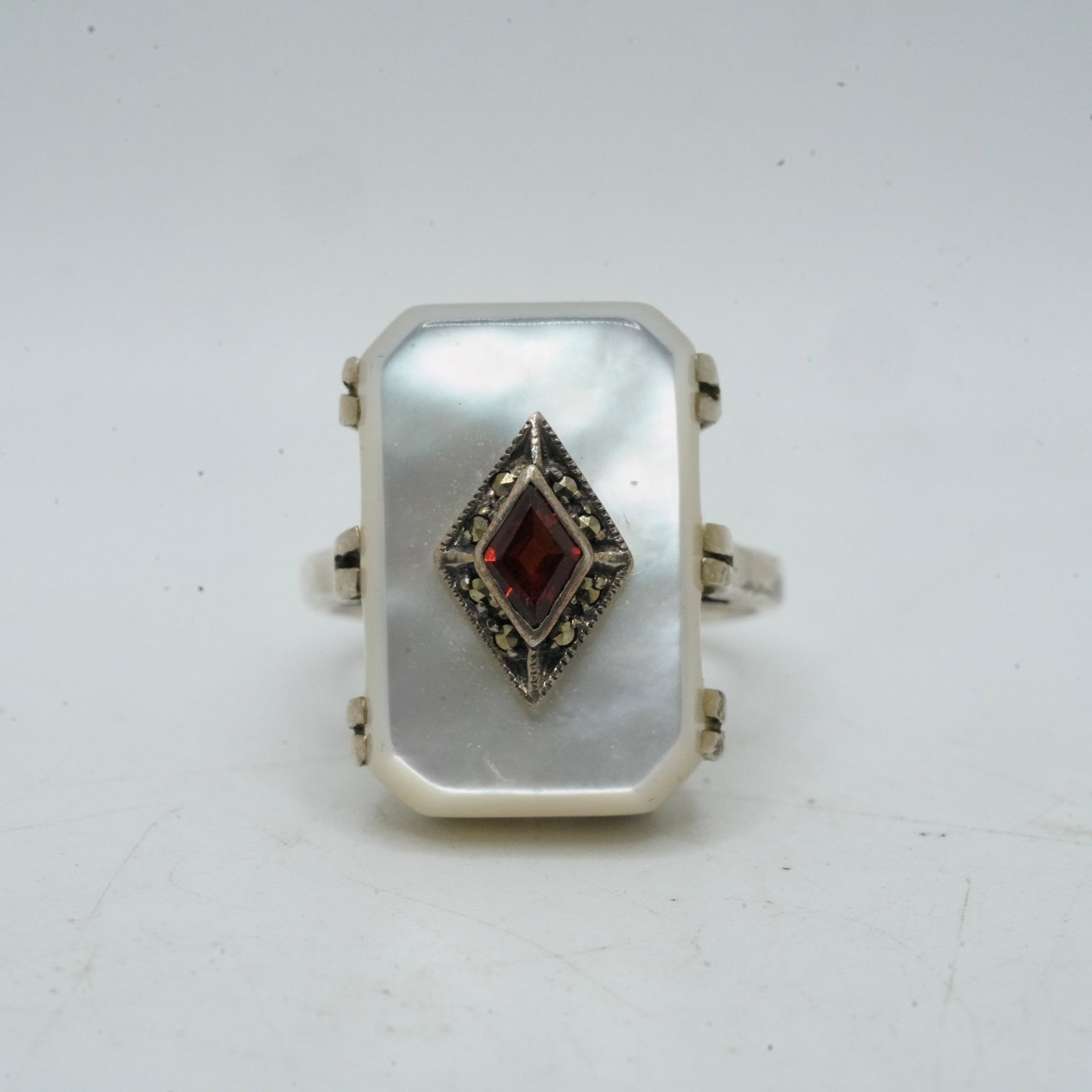7.32 Grams .925 Sterling Silver CNA, MOP, Garnets and Marcasites Ring Size 7, 3/4 in. x 7/8 in.: 7.32 Grams .925 Sterling Silver CNA, MOP, Garnets and Marcasites Ring Size 7, 3/4 in. x 7/8 in.