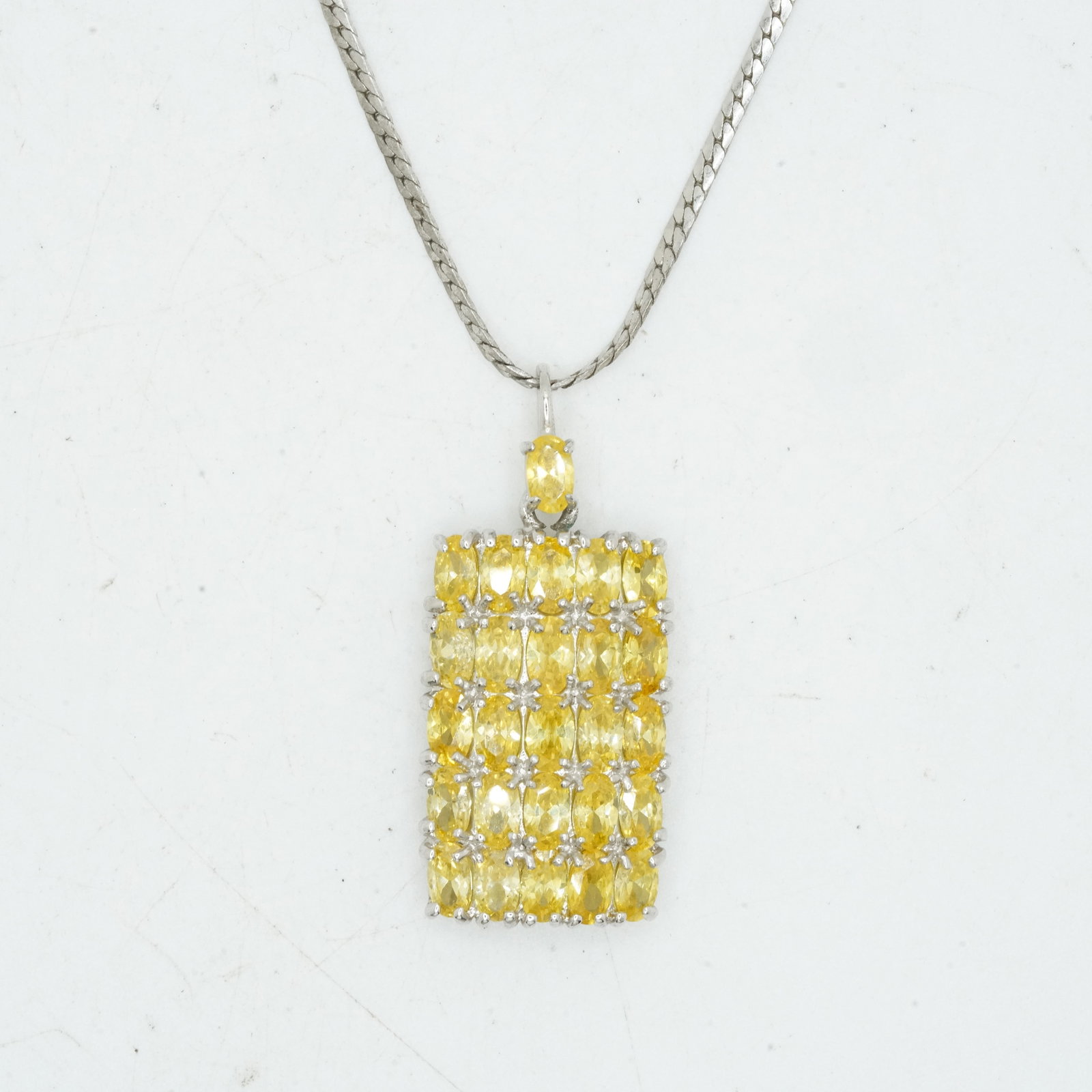 11.39 Grams .925 Sterling Silver Yellow Tourmaline Pendant Necklace on Sterling 18 in. Chain: 11.39 Grams .925 Sterling Silver Yellow Tourmaline Pendant Necklace on Sterling 18 in. Chain. Pendant Size: 1 1/2 in. x 5/8 in.