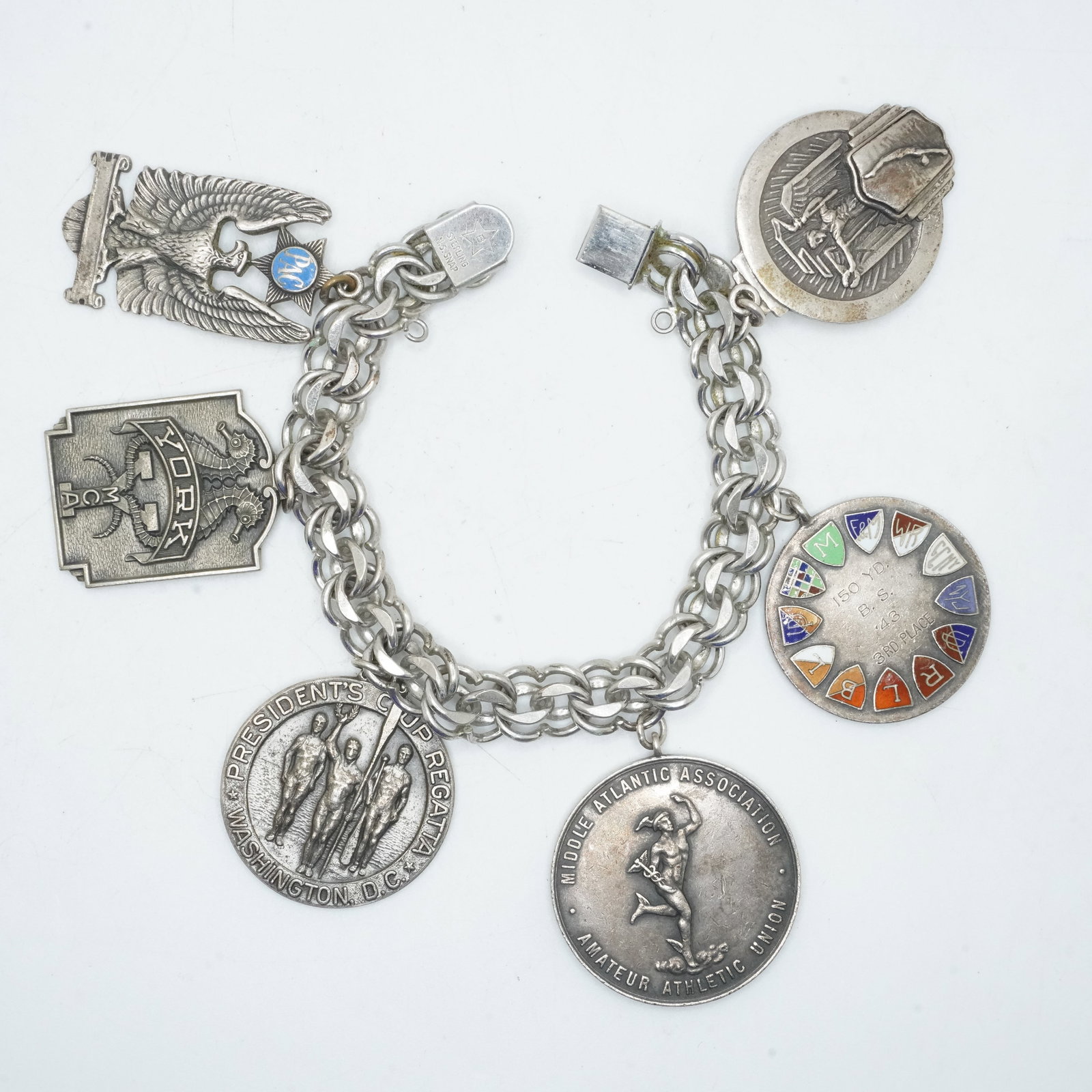 112.45 Grams .925 Sterling Silver Charm Bracelet with 5 Sterling Charms [York Not Sterling]: 112.45 Grams .925 Sterling Silver Charm Bracelet with 5 Sterling Charms [York Not Sterling] chain 7 3/4 in. x 1/2 in. ; coins average 1 1/2 in. dia.