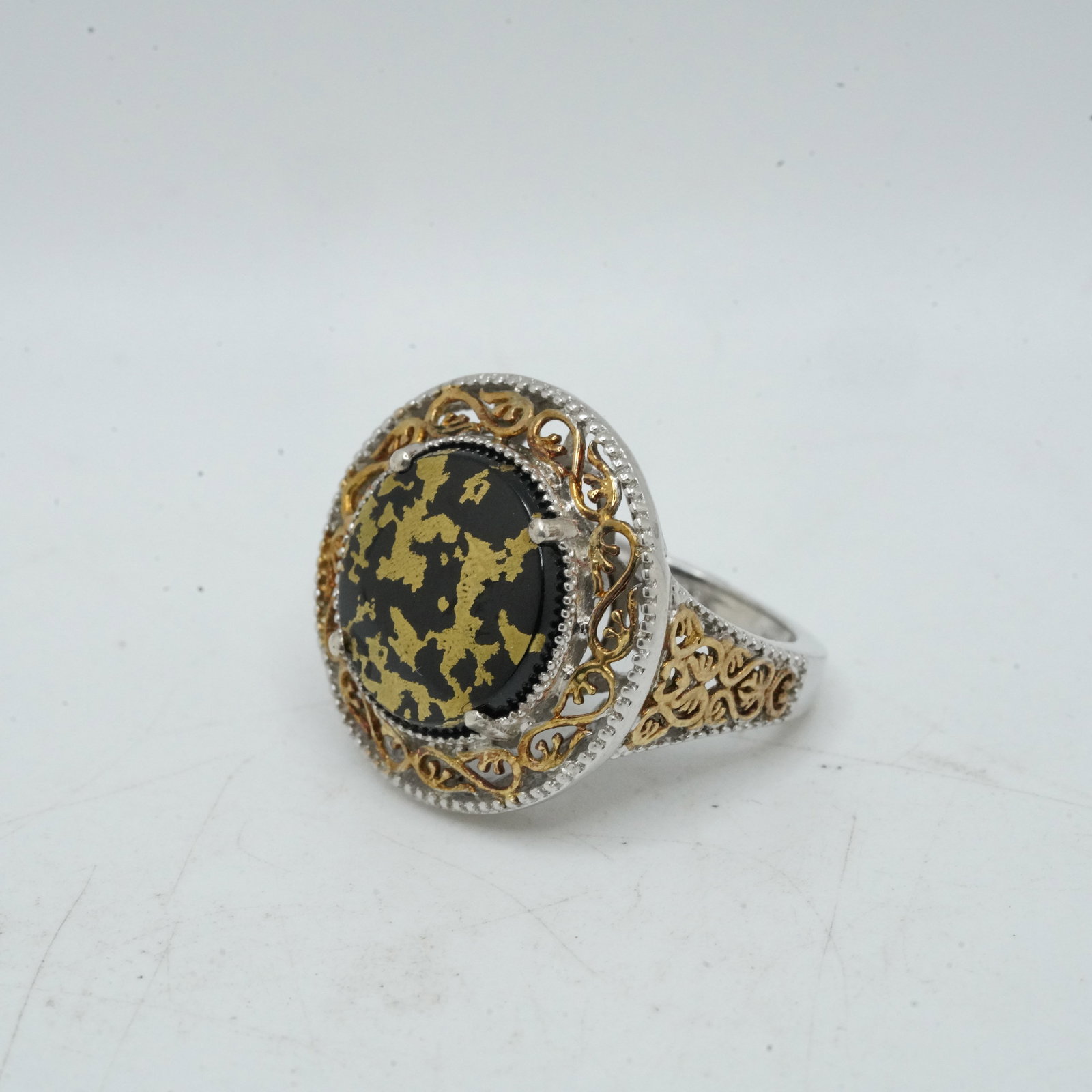 7.36 Grams .925 Sterling Silver and 14K Gold with Black Onyx Ring Size 7 Surrounded by Silver: 7.36 Grams .925 Sterling Silver and 14K Gold with Black Onyx Ring Size 7 Surrounded by Silver and Gold Filigree Frame - Stunning - 1 in. dia.