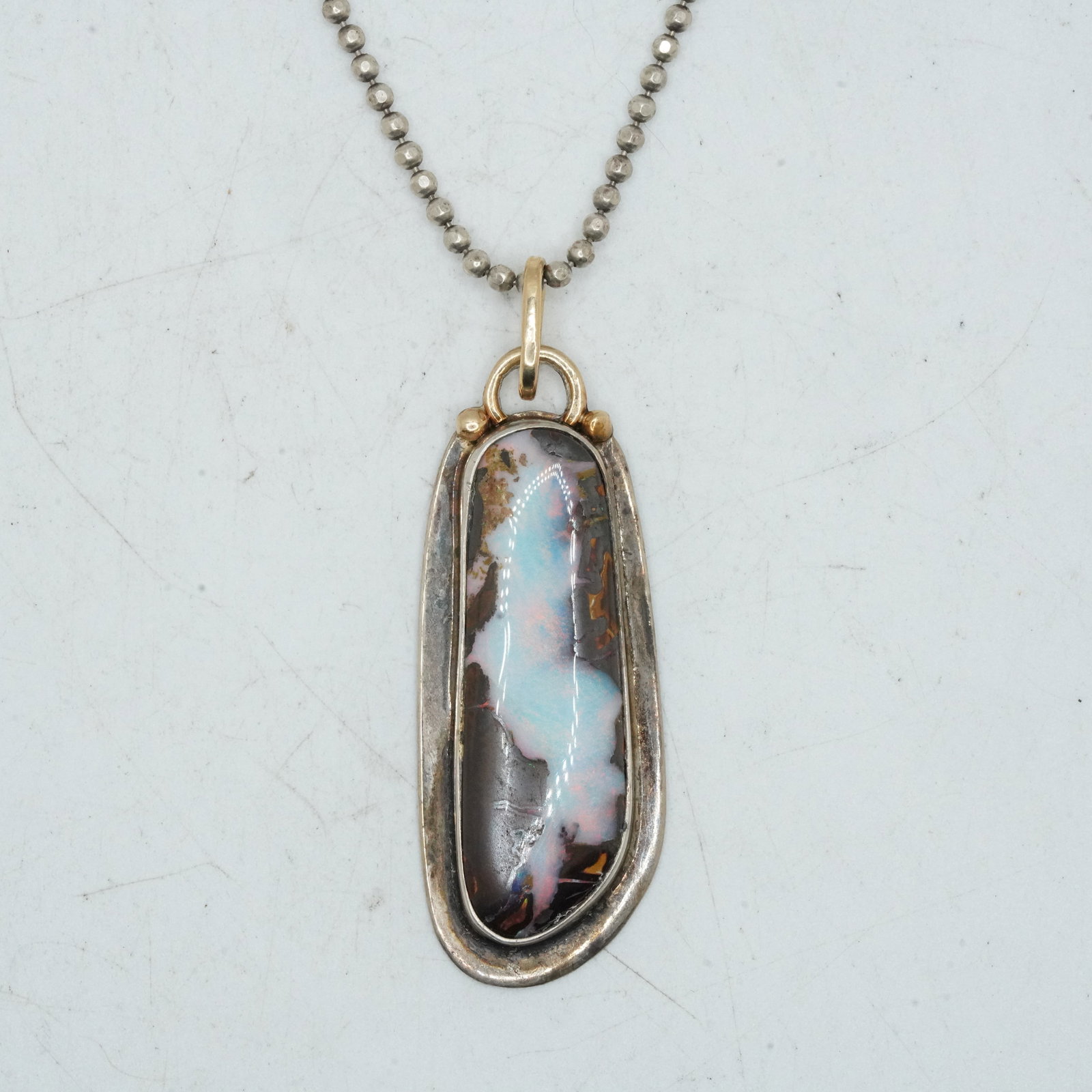 19.70 Grams Sterling Silver and 14K Gold B. Lambard Opal Bleeding into Tigers Eye Pendant: 19.70 Grams Sterling Silver and 14K Gold B. Lambard Opal Bleeding into Tigers Eye Pendant Necklace. .925 Sterling Chain 18 in. ; pendant 2b in. x 3/4 in.