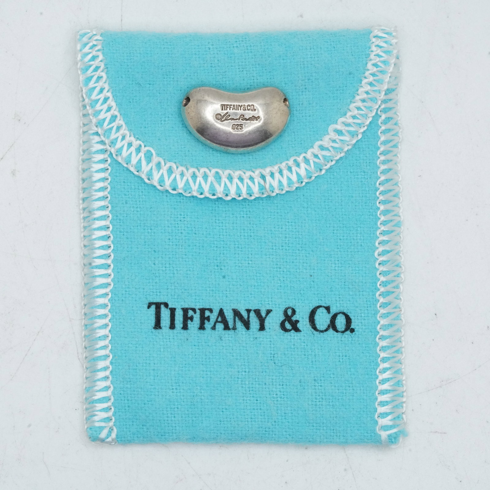 6.84 Grams TIFFANY & CO .925 Sterling Silver Elsa Peretti Bean Pendant with Fabric Pouch: 6.84 Grams TIFFANY & CO .925 Sterling Silver Elsa Peretti Bean Pendant with Fabric Pouch ; 3/4 in. x 1/2 in.