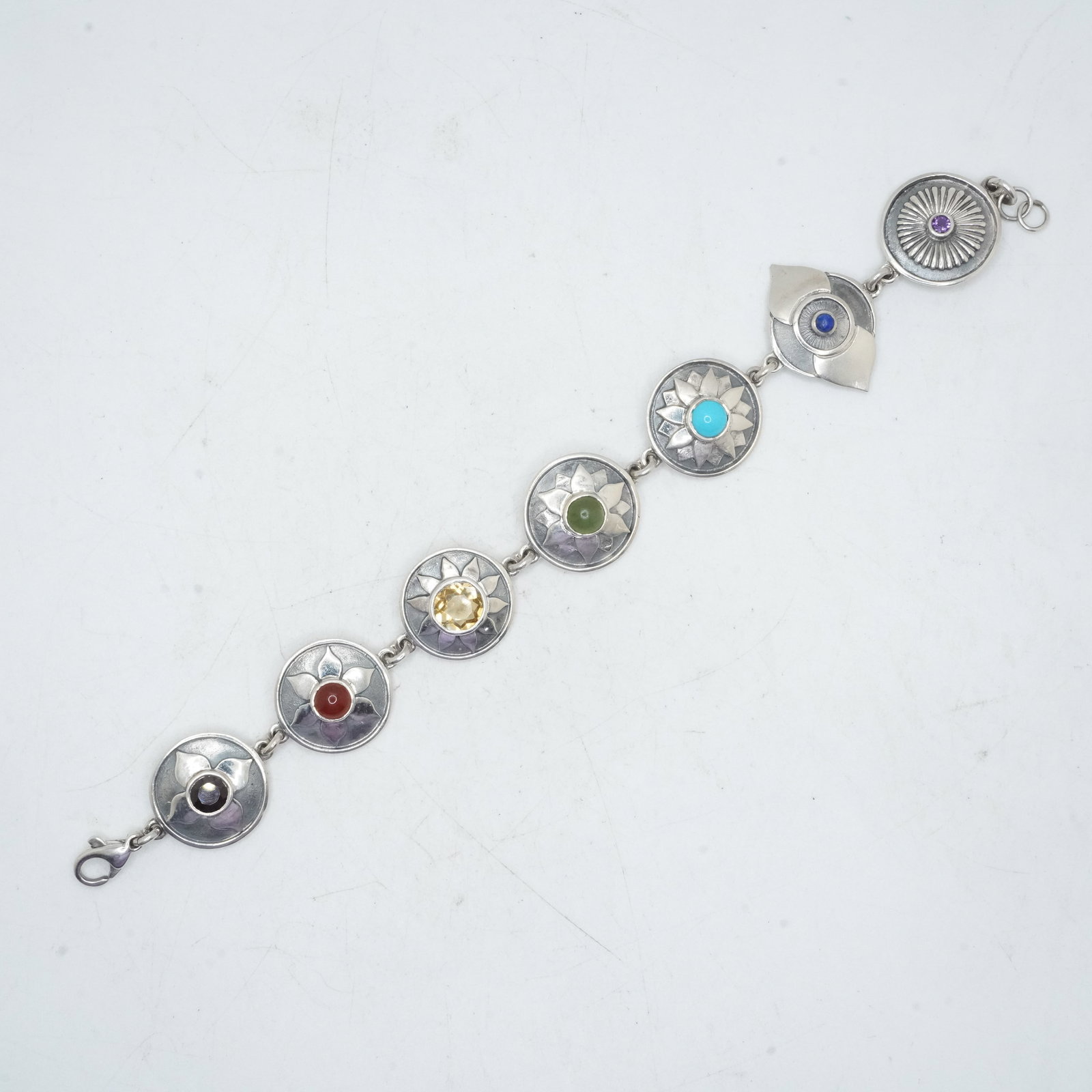 22.75 Grams .925 Sterling Silver Native American Indian 7-Round Panels Bracelet with Purple: 22.75 Grams .925 Sterling Silver Native American Indian 7-Round Panels Bracelet with Purple Amethyst , Lapis, Turquoise, Jade, Citrine, Amber, Garnets. 7 1/2 in. x 3/4 in.