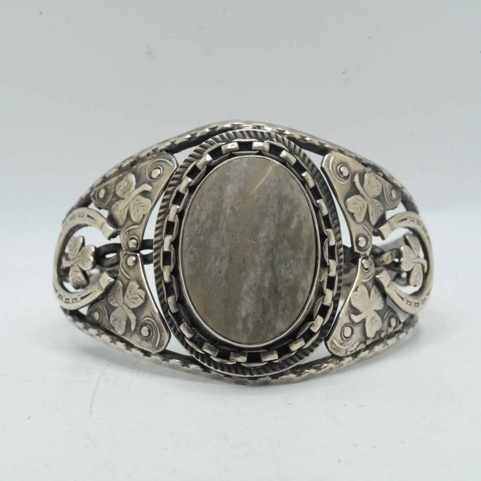 50.06 Grams Sterling Silver Genune Stone From Ground of Barley Castle Ireland Cuff Bracelet: 50.06 Grams Sterling Silver Genune Stone From Ground of Barley Castle Ireland Cuff Bracelet, Horseshoe and 3 Clover Leaf Symbols. Size: 2 1/4 in. x 2 3/8 in. x 1 5/8 in.