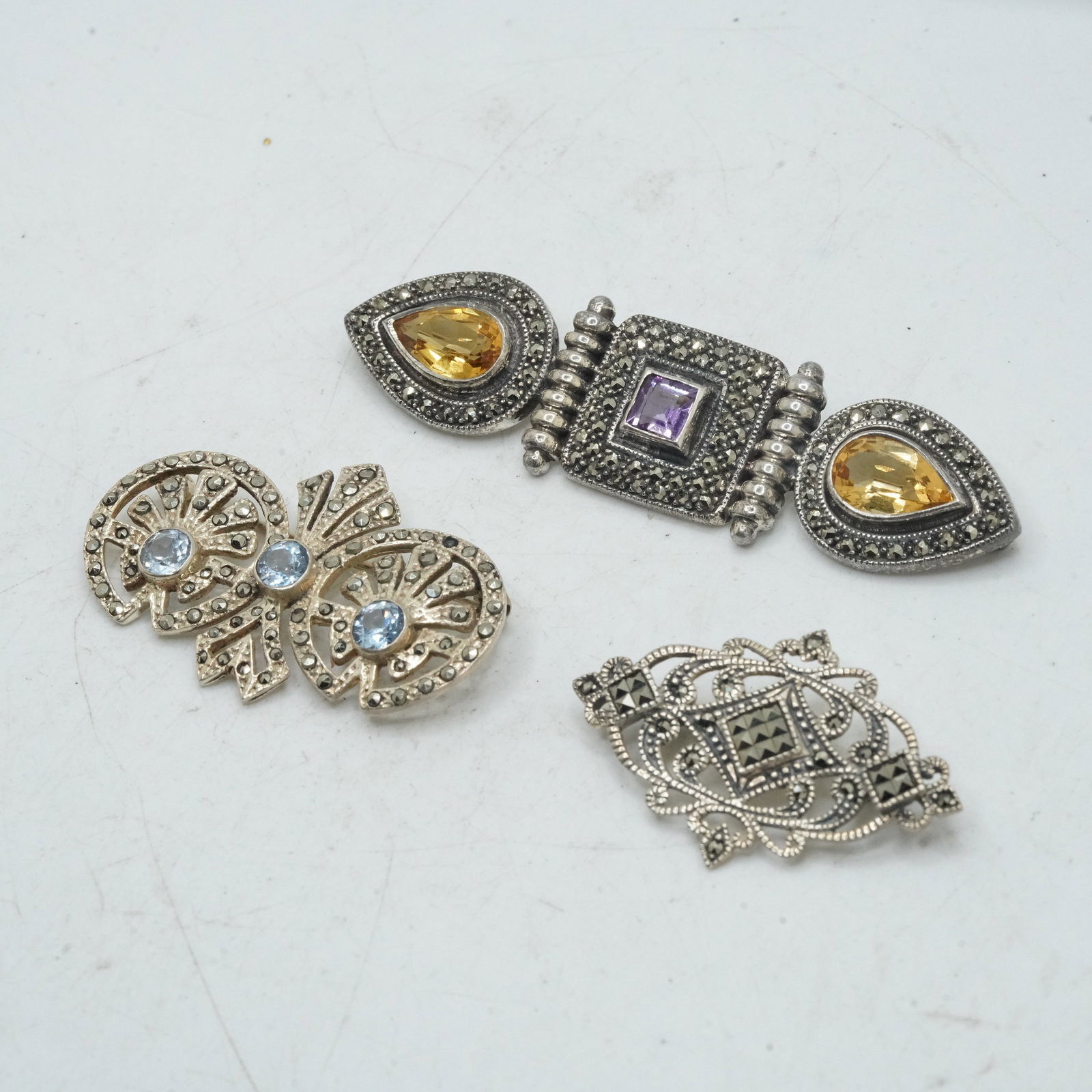 40.28 Grams .925 Sterling Silver and Marcasite Pins: .925 Victorian Marcasite Pin 1 3/4 in. x 1 1/4: 40.28 Grams .925 Sterling Silver and Marcasite Pins: .925 Victorian Marcasite Pin 1 3/4 in. x 1 1/4 in.; .925 Vintage 1920s-30s Pin with Marcasites and 2 Citrines and Purple Amethyst marked Sterling J