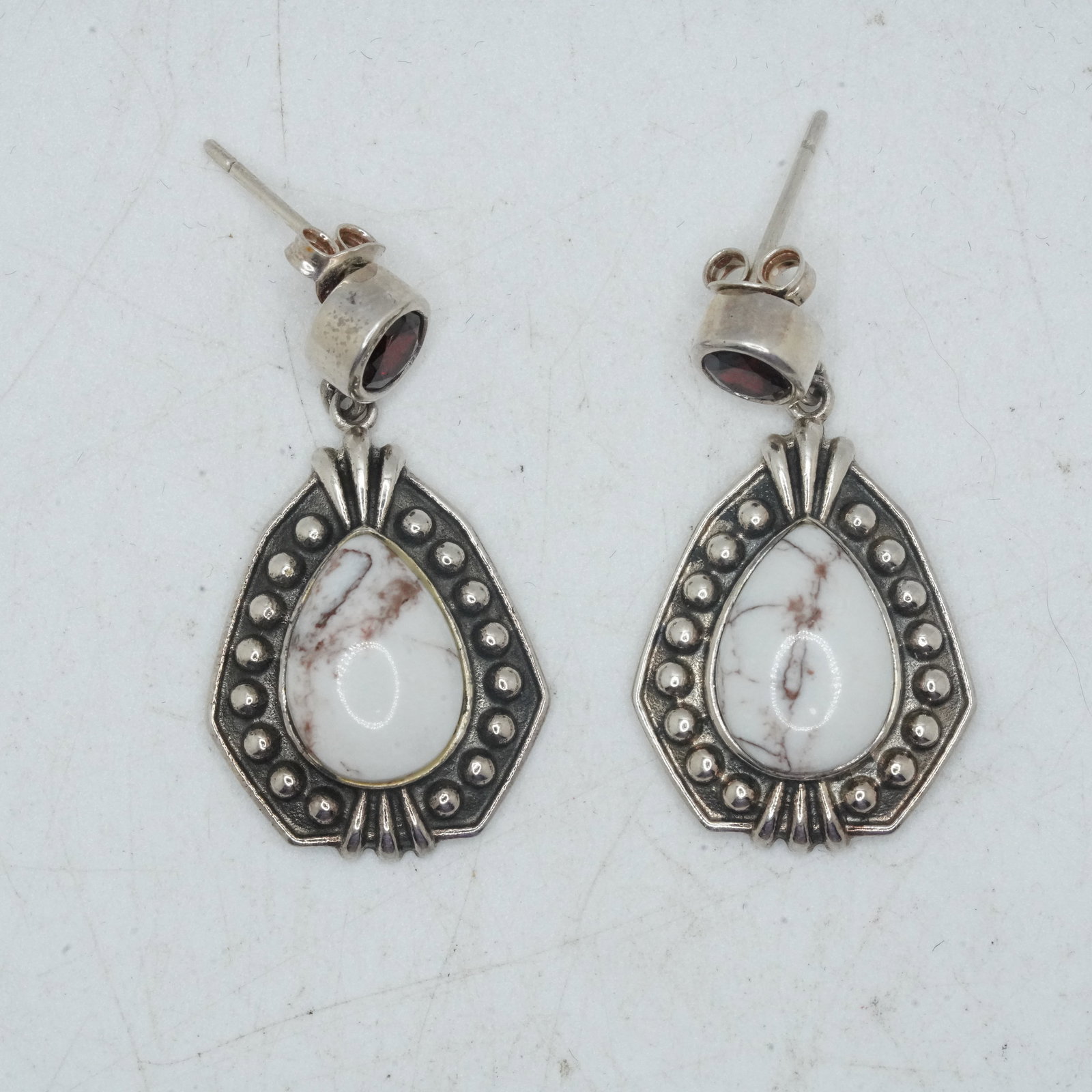 7.74 Grams .925 Sterling Silver Drop Earrings with Tear Drop Center Howlite and Garnet Sone Stud: 7.74 Grams .925 Sterling Silver Drop Earrings with Tear Drop Center Howlite and Garnet Sone Stud, 1 3/8 in. x 3/4 in.