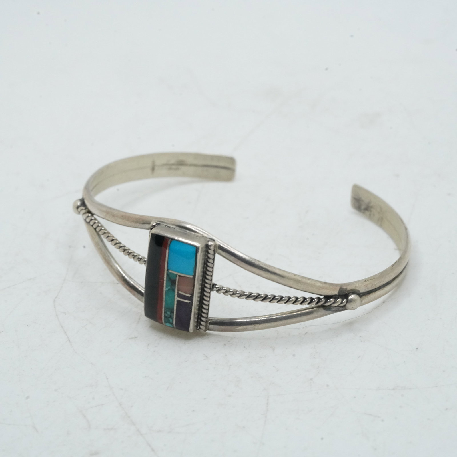11.45 Grams Sterling Silver Native American Indian Zuni Cuff Bracelet with Inlaid Black Onyx ,: 11.45 Grams Sterling Silver Native American Indian Zuni Cuff Bracelet with Inlaid Black Onyx , Turquoise, Malachite, Coral, Lapis and Purple Amethyst. 2 3/8 in. x 2 in. x 3/4 in.
