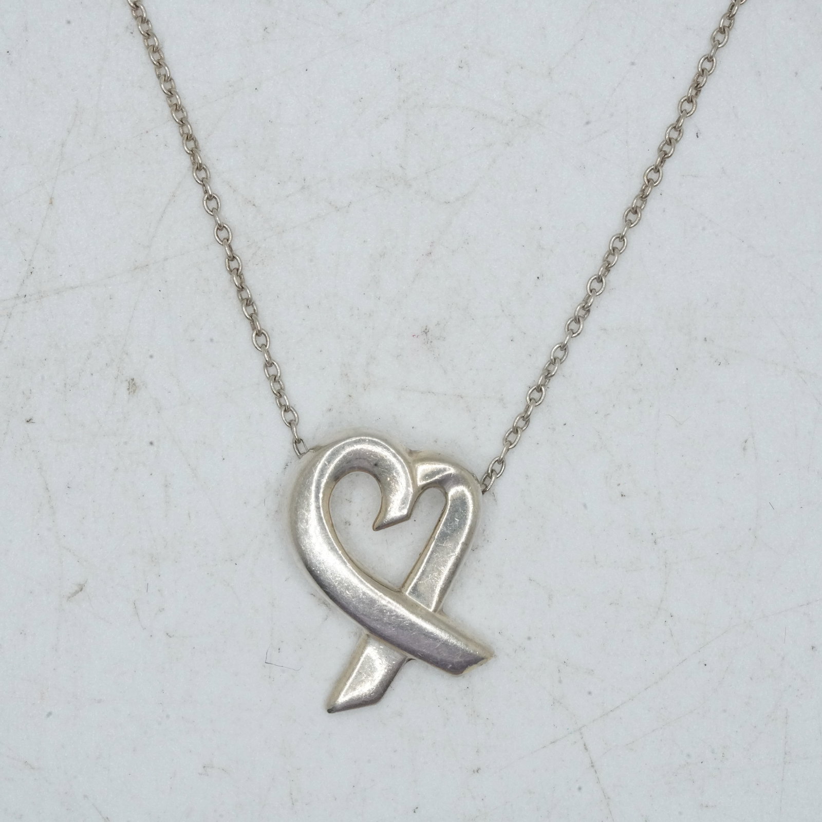 2.80 Grams TIFFANY & CO, T & Co, .925 Sterling Silver Paloma Picasso Loving Heart Pendant: 2.80 Grams TIFFANY & CO, T & Co, .925 Sterling Silver Paloma Picasso Loving Heart Pendant 1/2 in. x 5/8 in. on a T & Co ,925 Sterling Paloma Picasso Chain 17 inch., with Fabric Pouch.