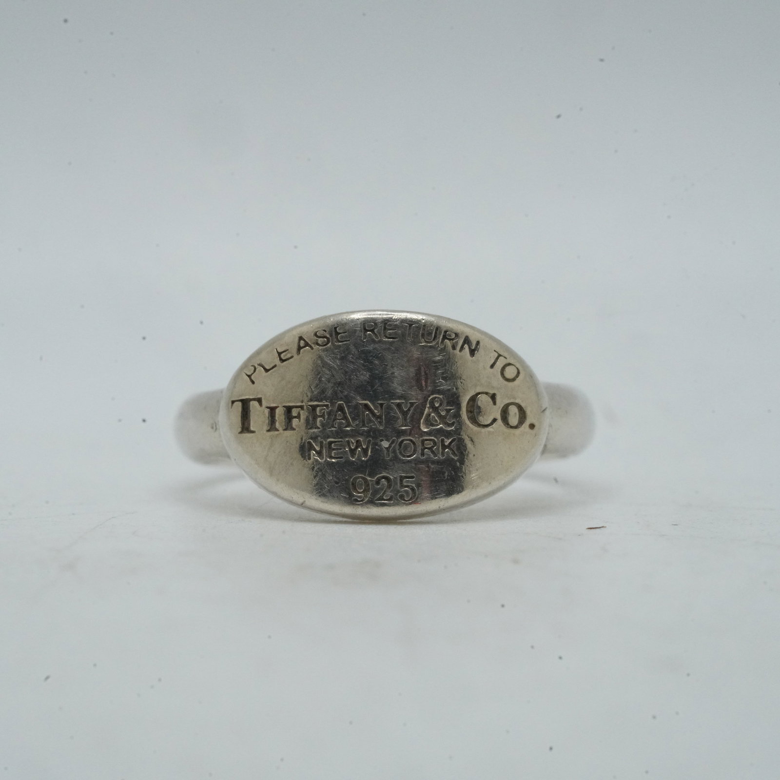 4.31 Grams .925 Sterling Silver TIFFANY & CO Ring Size 6, "Please Return To Tiffany & Co": 4.31 Grams .925 Sterling Silver TIFFANY & CO Ring Size 6, "Please Return To Tiffany & Co", 3/4 in. x 3/8 in., with Fabric Pouch