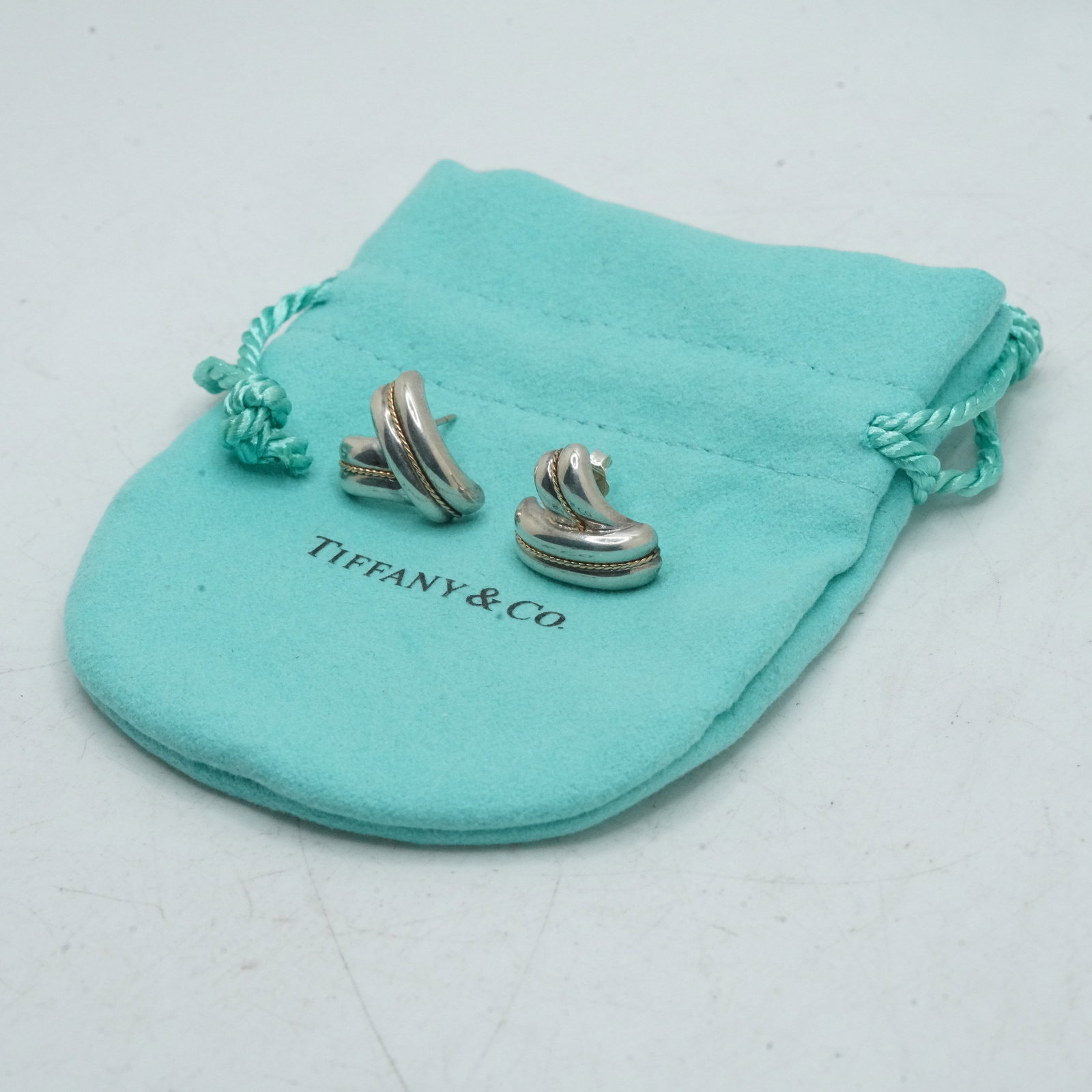Tiffany & Co .925 Sterling Silver and 585 [14K Gold] 4.77 Grams Rope "V" Shaped Earrings wuth Fabric: Tiffany & Co .925 Sterling Silver and 585 [14K Gold] 4.77 Grams Rope "V" Shaped Earrings wuth Fabric Pouch and Box. Size: Earrings 3/4 in. x 5/8 in.