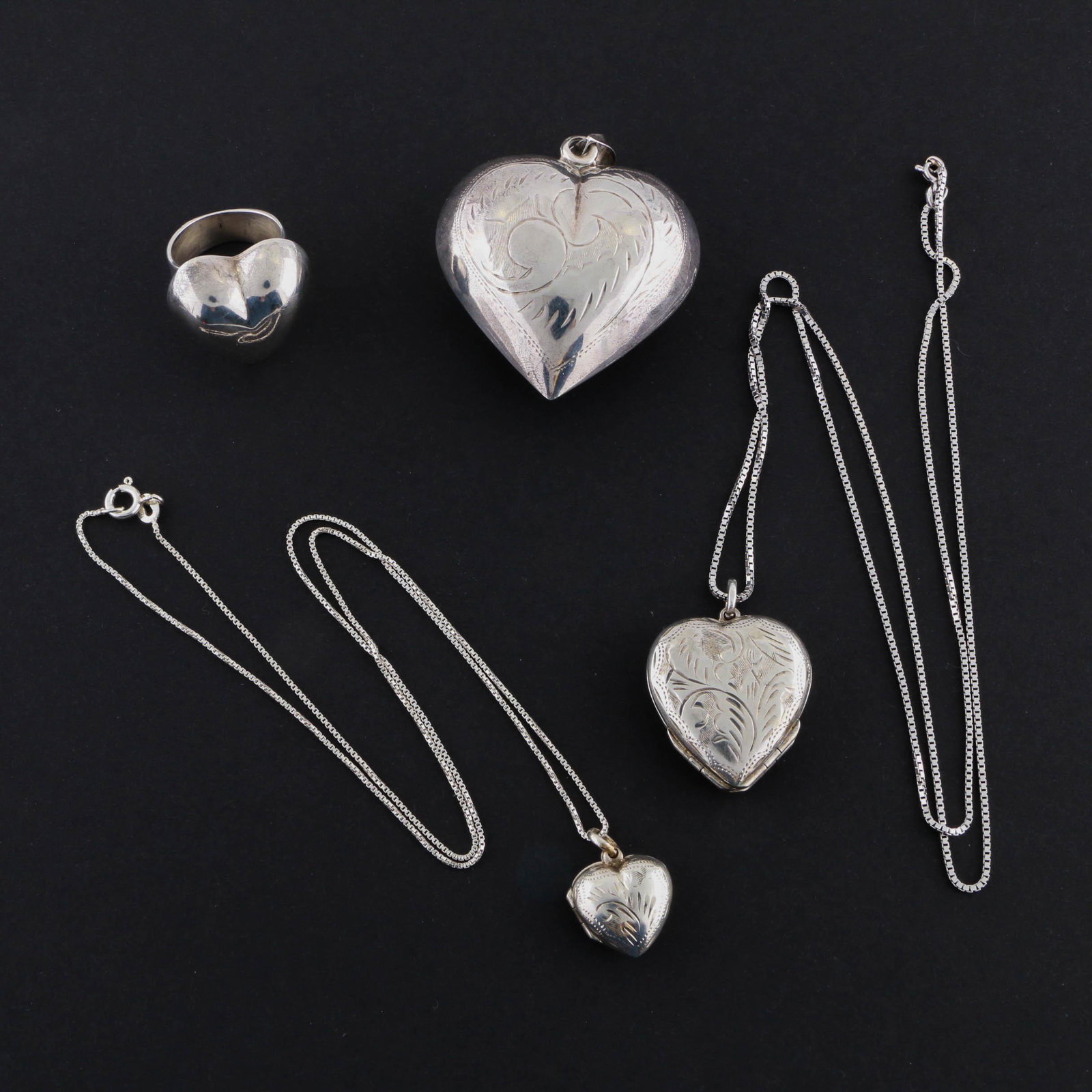 Sterling Silver Locket Necklaces, Holloware Silver: Hand engraved sterling silver locket necklaces, holloware heart pendant, and ring. Material: Sterling Silver Size: 28.00'', 20.00'' Weight:1.865 ozt