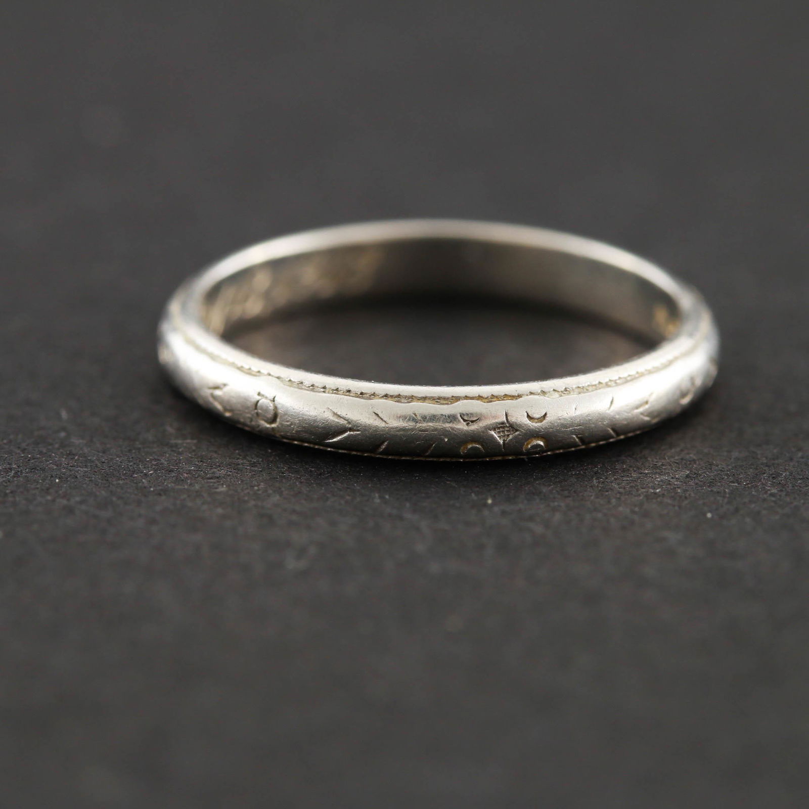 1918 Engraved Platinum Band: Hand engraved platinum band dated 1918 with inscribed monograms. Material: Platinum Size: 5 Weight: 1.5 dwt Hallmark: C.H.J. to C.E.H. 1918, Platinum