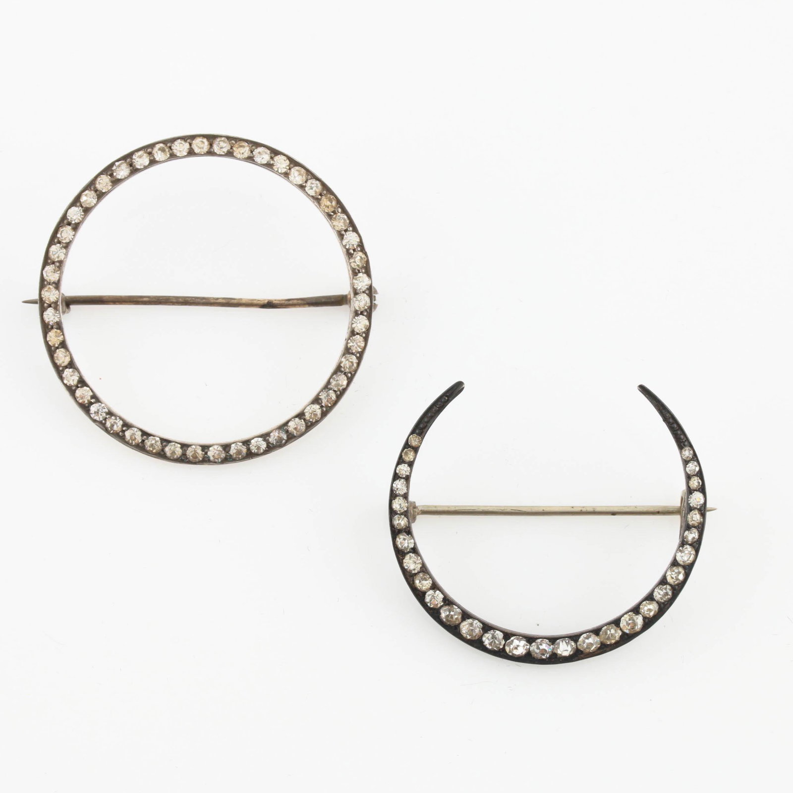 Sterling Silver Paste Half Moon Brooches: Two sterling silver paste half moon brooches. Material: sterling silver Size: 1.5" W Weight: 0.325 ozt Hallmark: Sterling