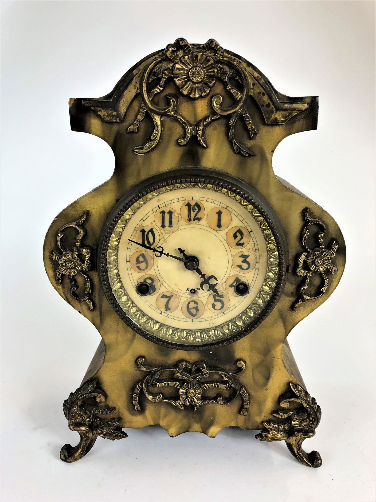 Antique Ormolu and Smoke Surface Shelf Clock: A flared shelf clock with ormolu feet and relief application, smoke decorated body, opening to reverse; ht. 13.25", wd. 9", dp. 4.5".