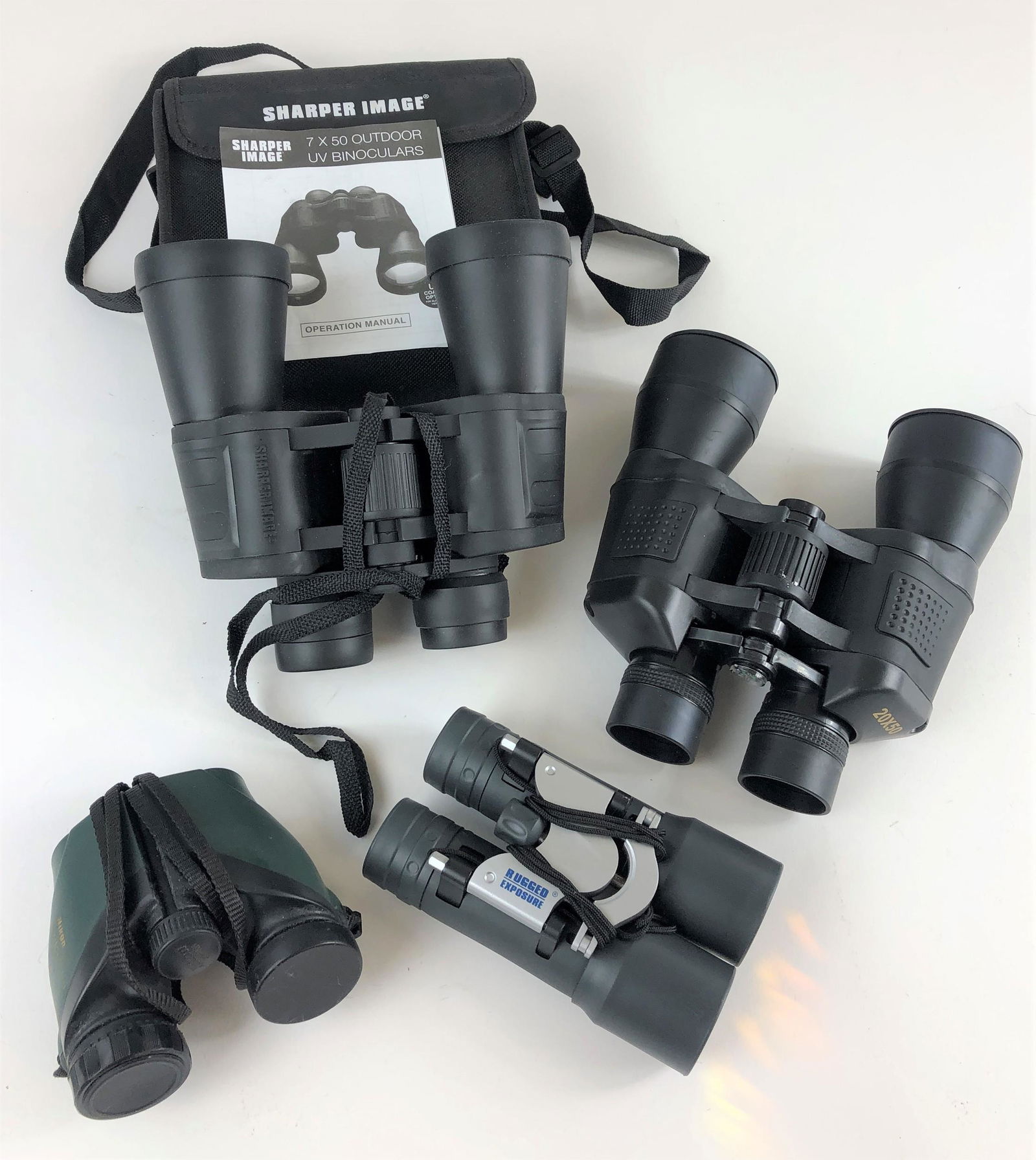 Group of 4 Paira of Binoculars: Includes pair of Nikon in case, pair of Rugged Exposure, Sharper Image, and pauir of 20 x 50 unidentified