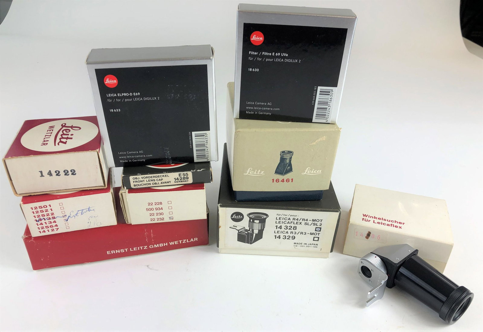 Collection of Leica Camera Accessories in Original: A group of 11 boxed Leica accessories, including a 16461 attachement, an R4 14 328 attachment, 3 adapter mounts, UV filters, and others