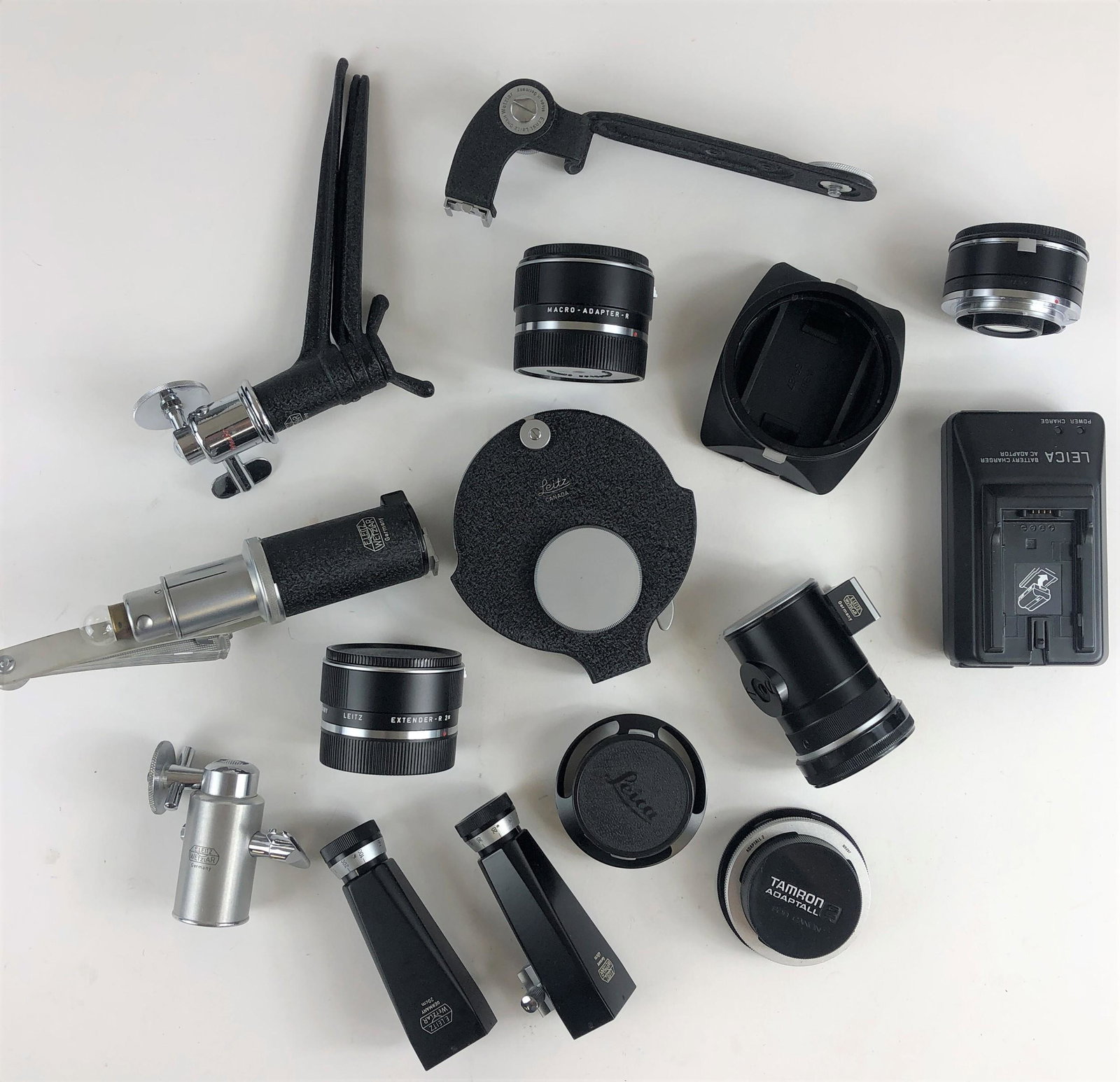 A Large Collection of Leica Camera Accessories,: A Large Collection of Leica Camera Accessories, Including Lens Guards, a Leica Battery Adapter and Charger, a Leica Extender-R 2X, a Leica Macro Adapter R, and More