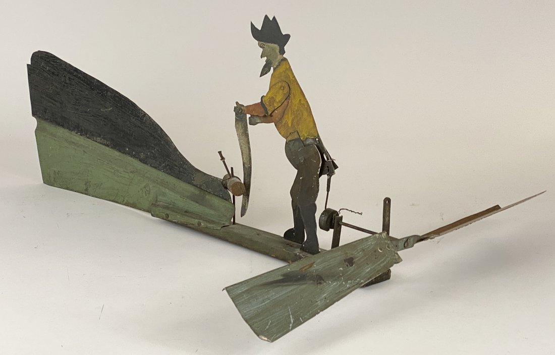 An American Folk Art Lumberjack Whirligig: American, late 19th century. Painted sheet metal and wood, depicting a sawing lumberjack; lg. 33".