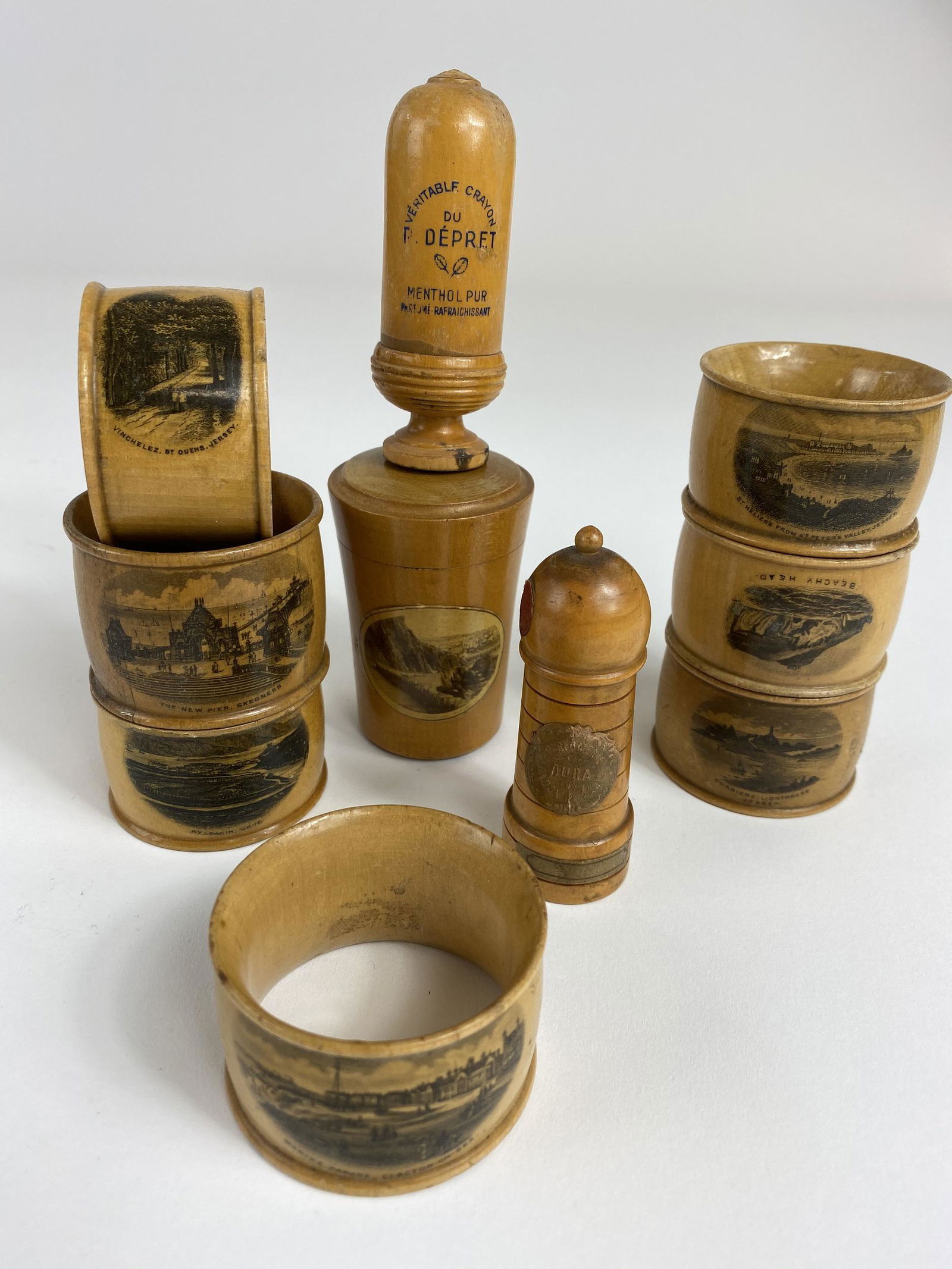 Group of 10 Mauchline Ware Table Items: Including 7 napkin rings, salt and pepper shaker and a shot glass. Tallest heigh: 3"