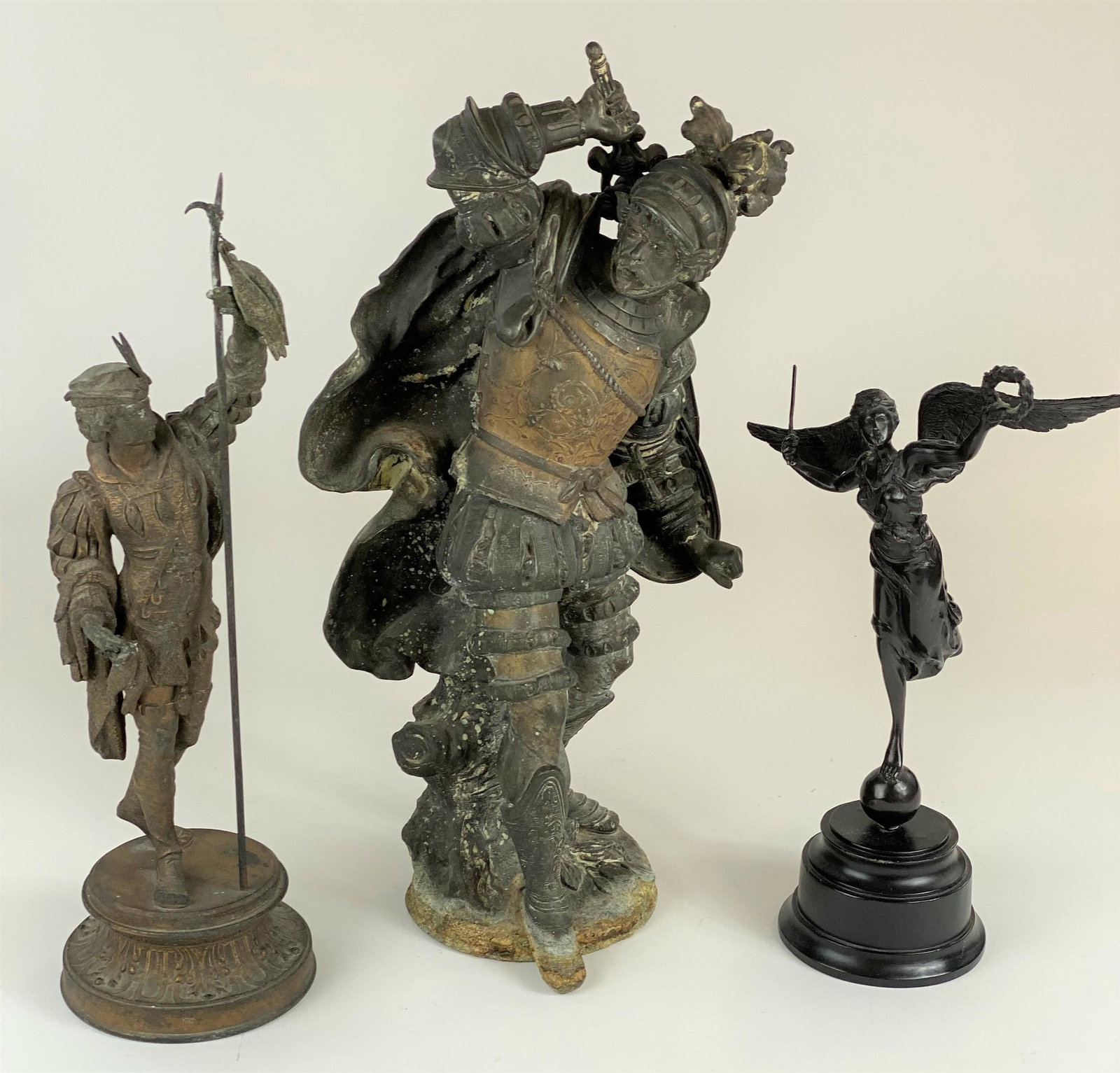 Three Continental Sculptures: Including a pair of spelter European sculptures, one depicting soldier and another a hunter, and a bronze mythological sculpture on a wood base. Tallest height: 21.5"