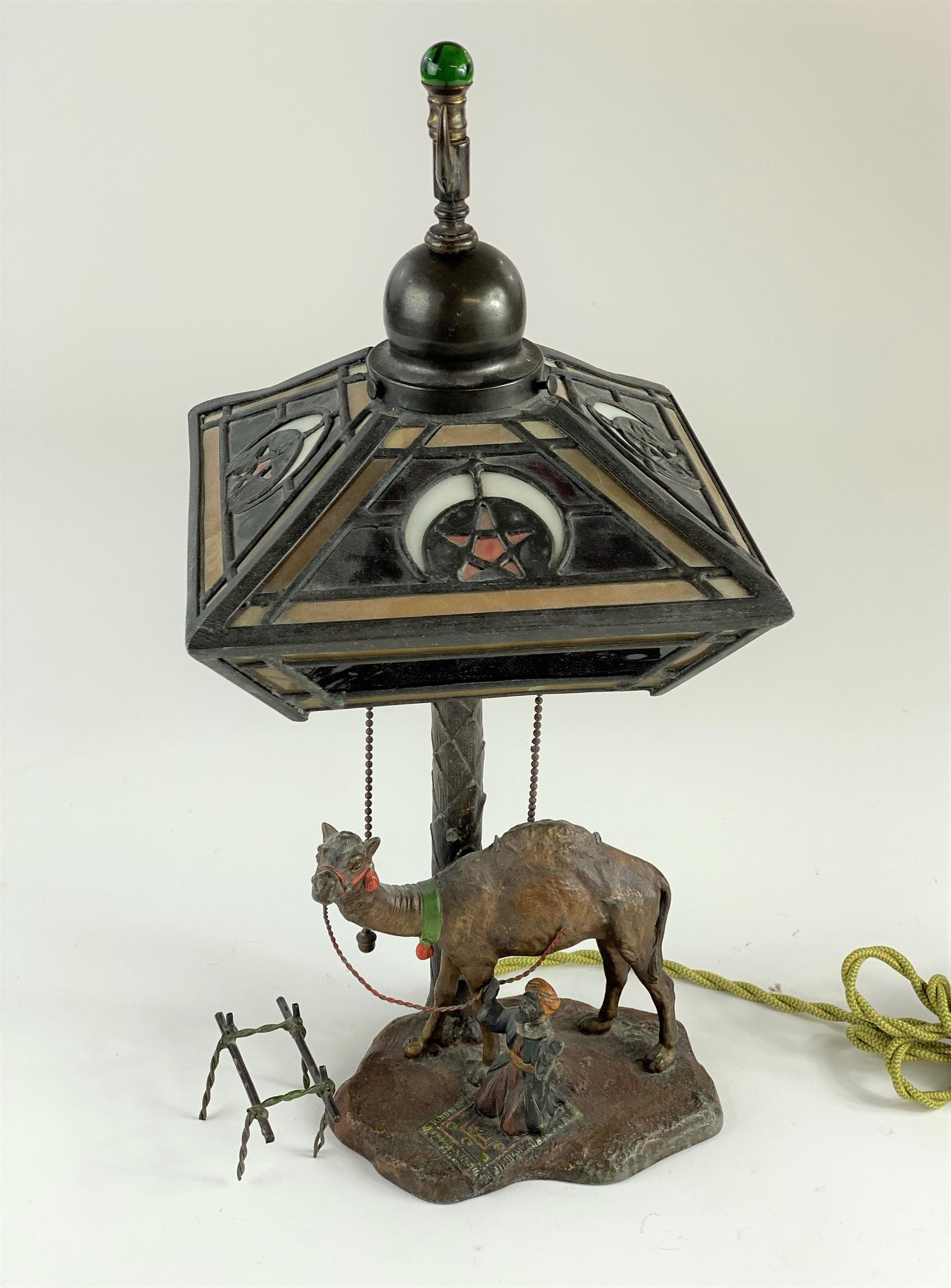 Cold Painted Austrian Lamp with Figure and Camel: A cast iron lamp with cold painted base and slag glass shade, marked "Austria" to the underside; ht. 18.5".